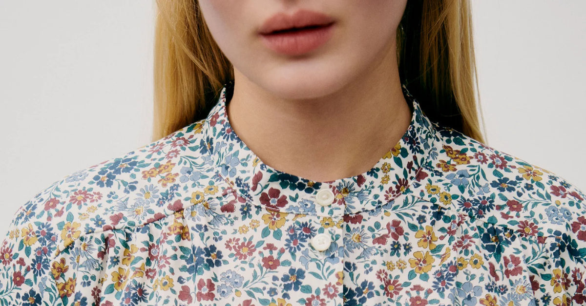 Woman in multi-colored floral patterned shirt with buttons