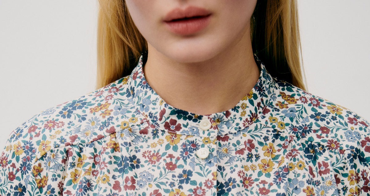 Woman in multicolored floral print shirt with buttons