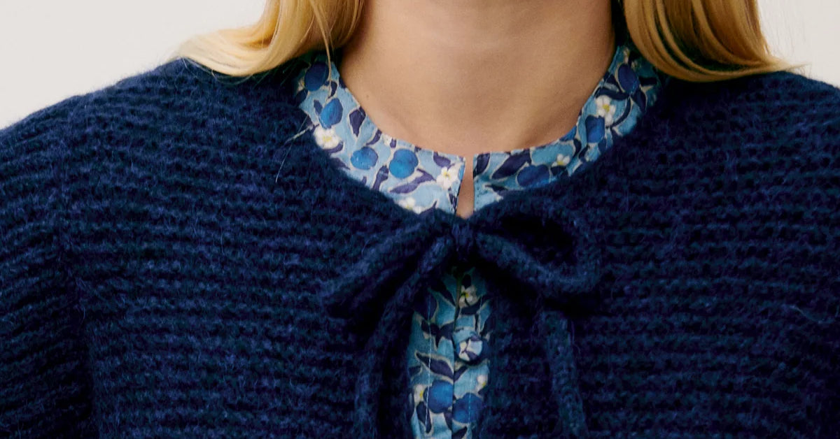 Blue knitted women's vest with bows