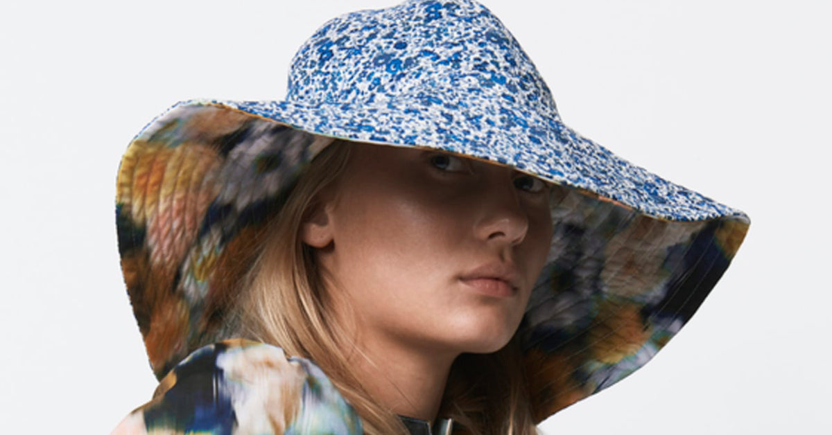 Woman in blue and white flower patterned large summer hat