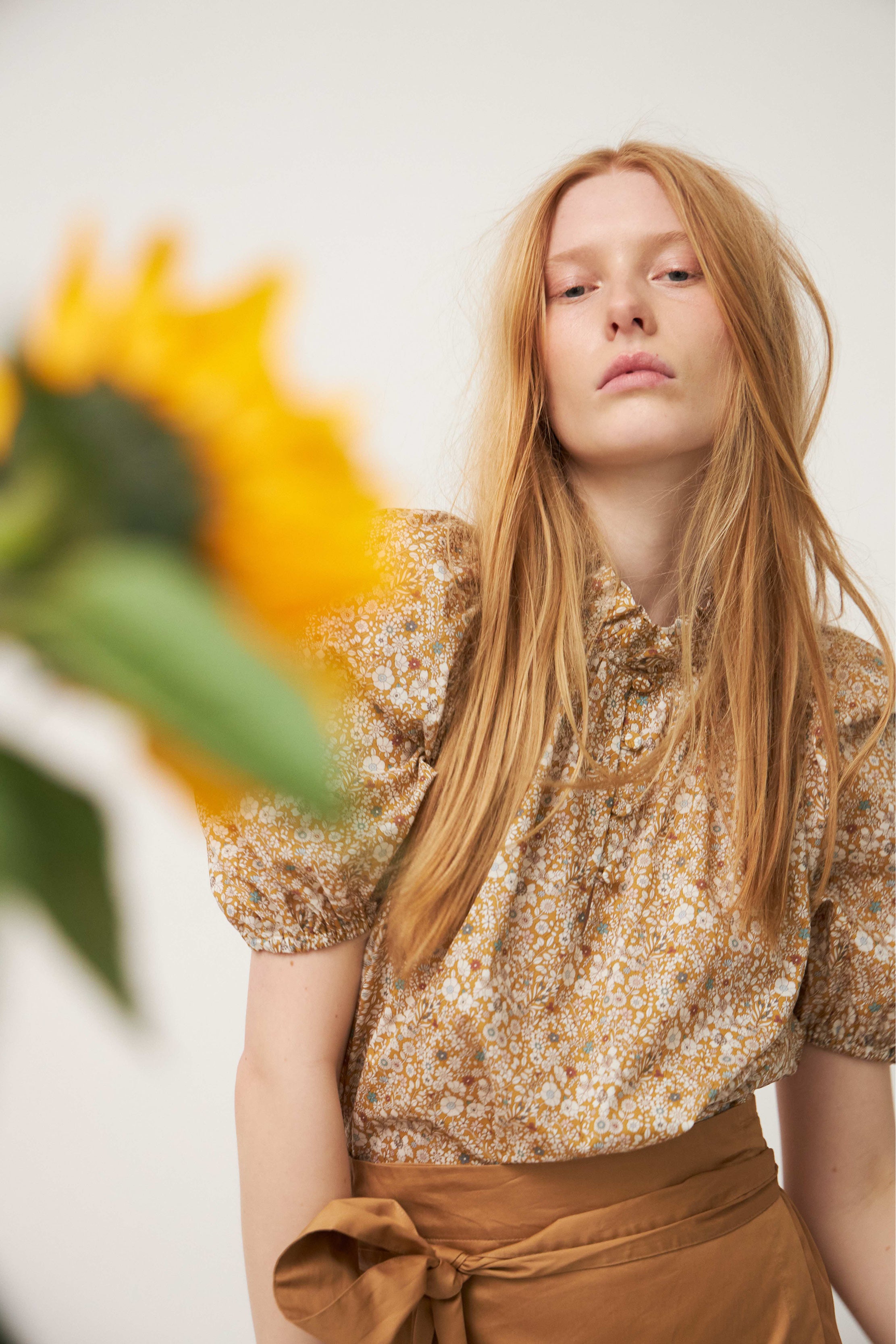 Sunflower and woman in flower patterned blouse