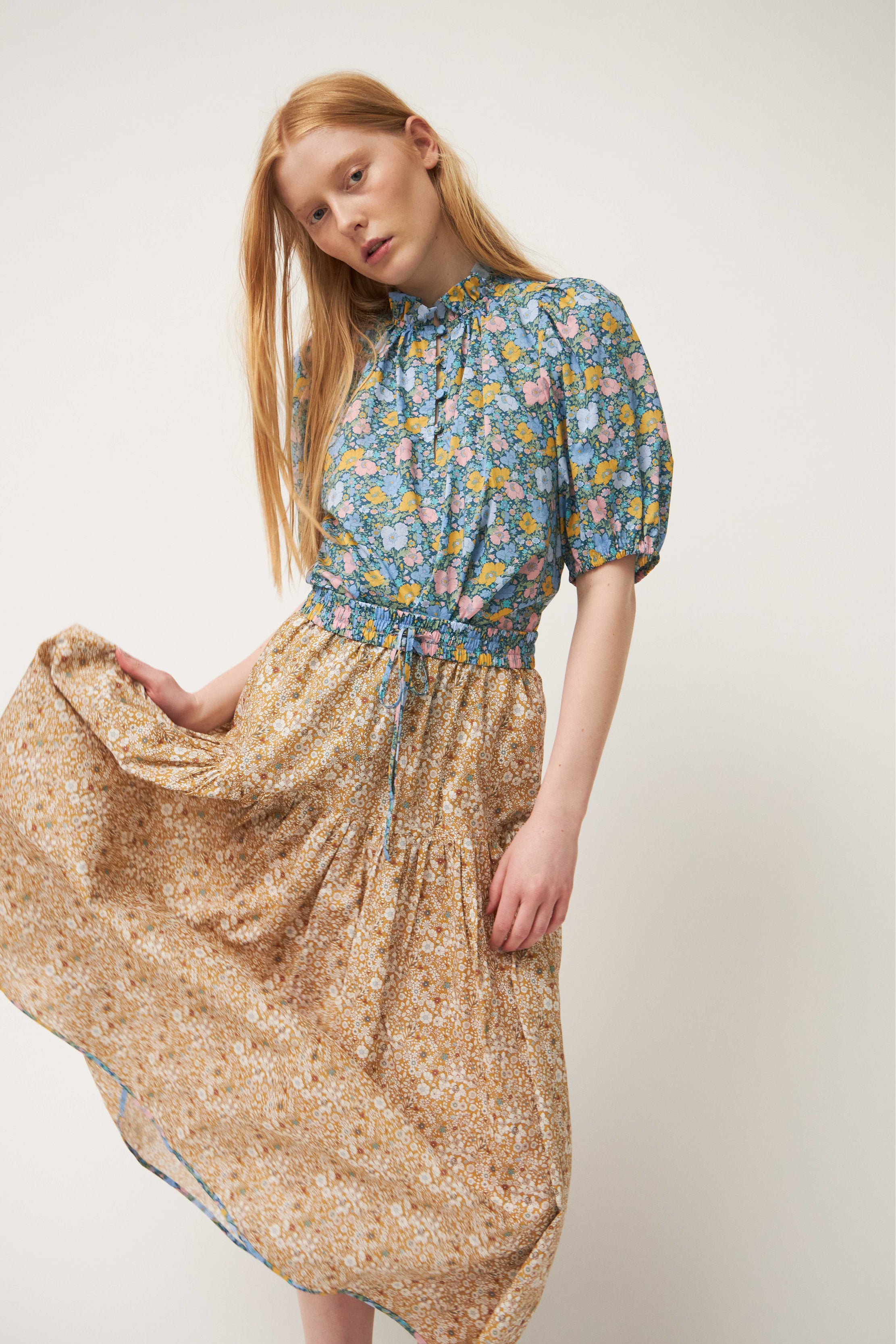 Woman in flower patterned blouse and skirt