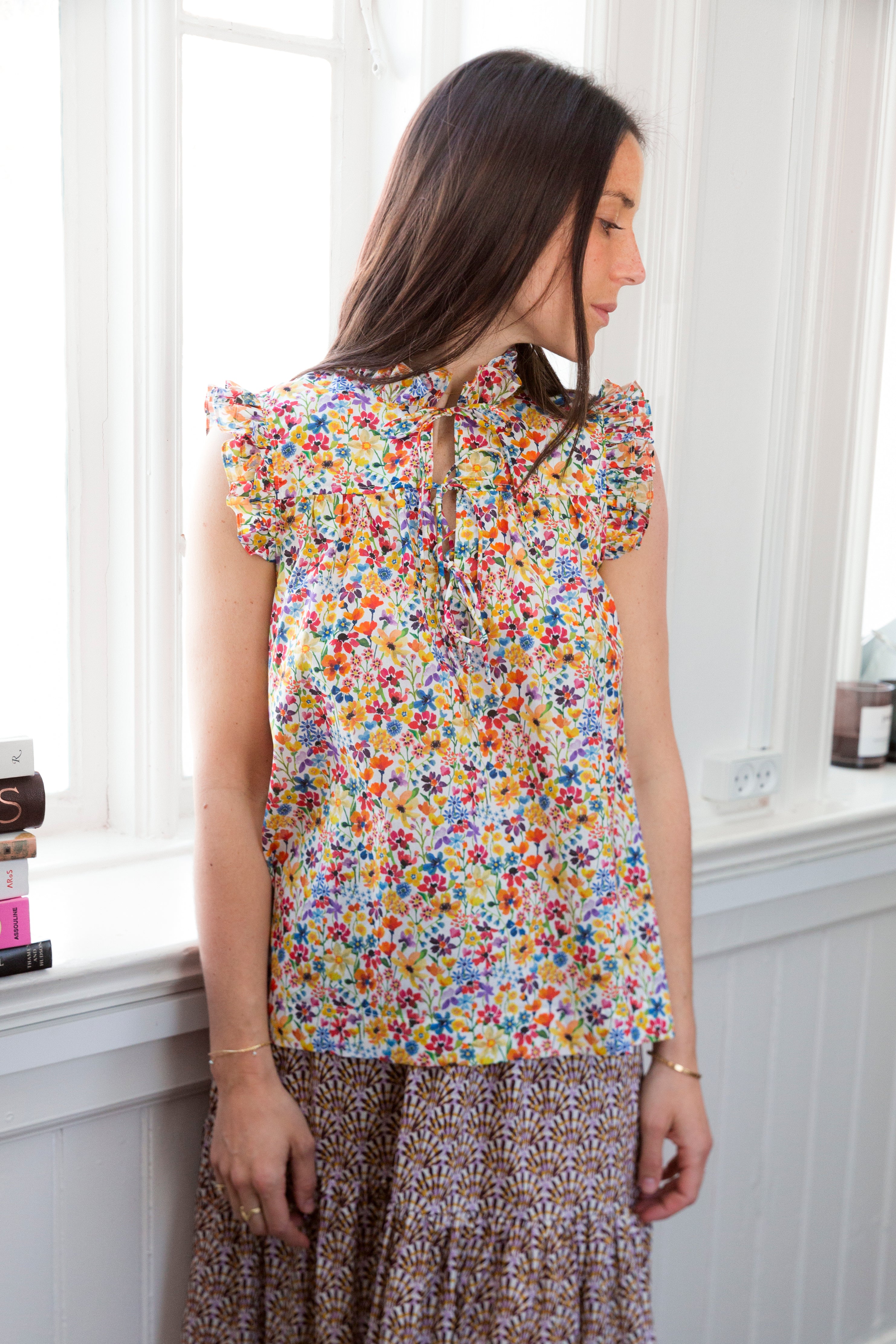 Woman in short sleeved blouse with flower pattern