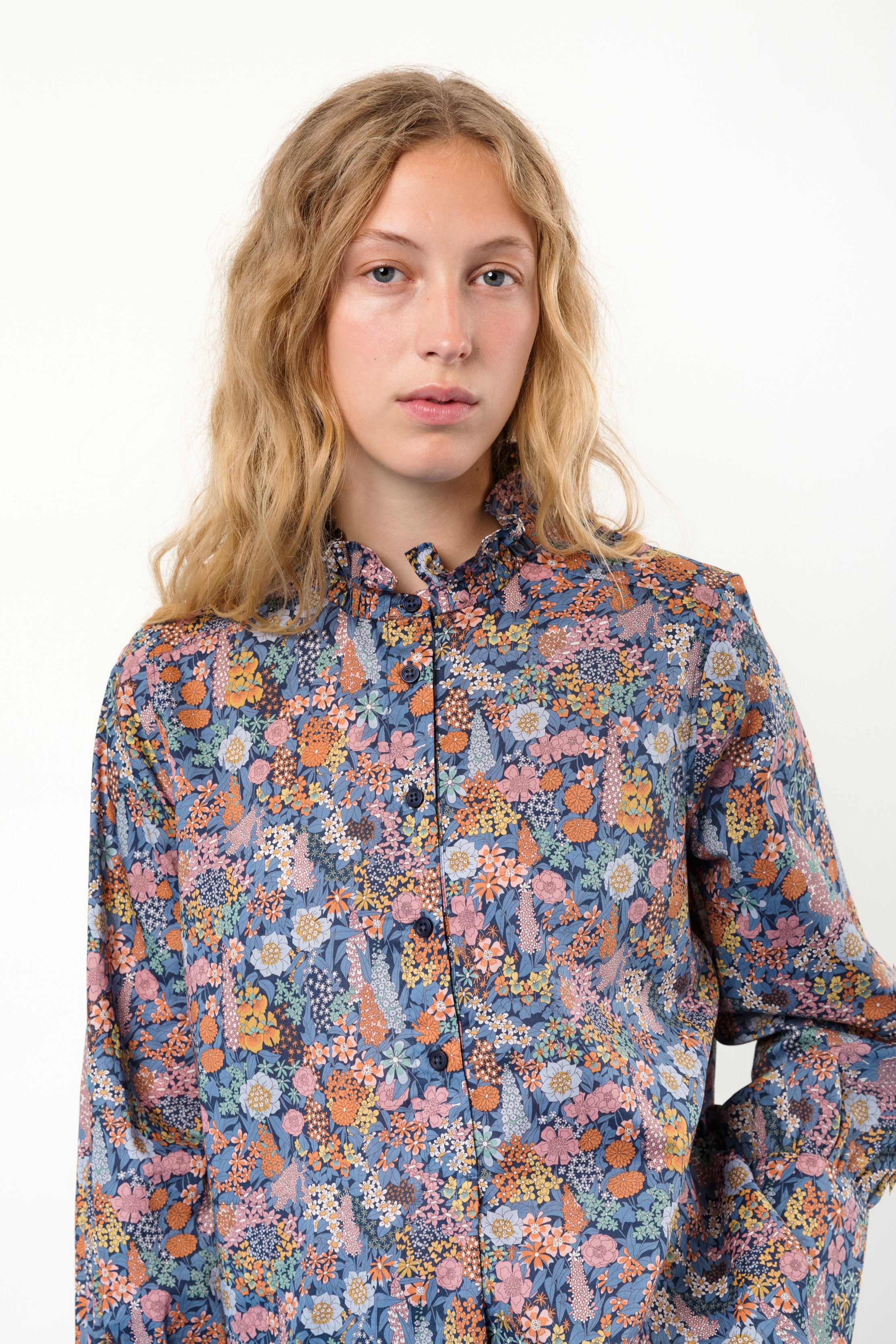 Woman wearing long sleeved shirt with flower pattern
