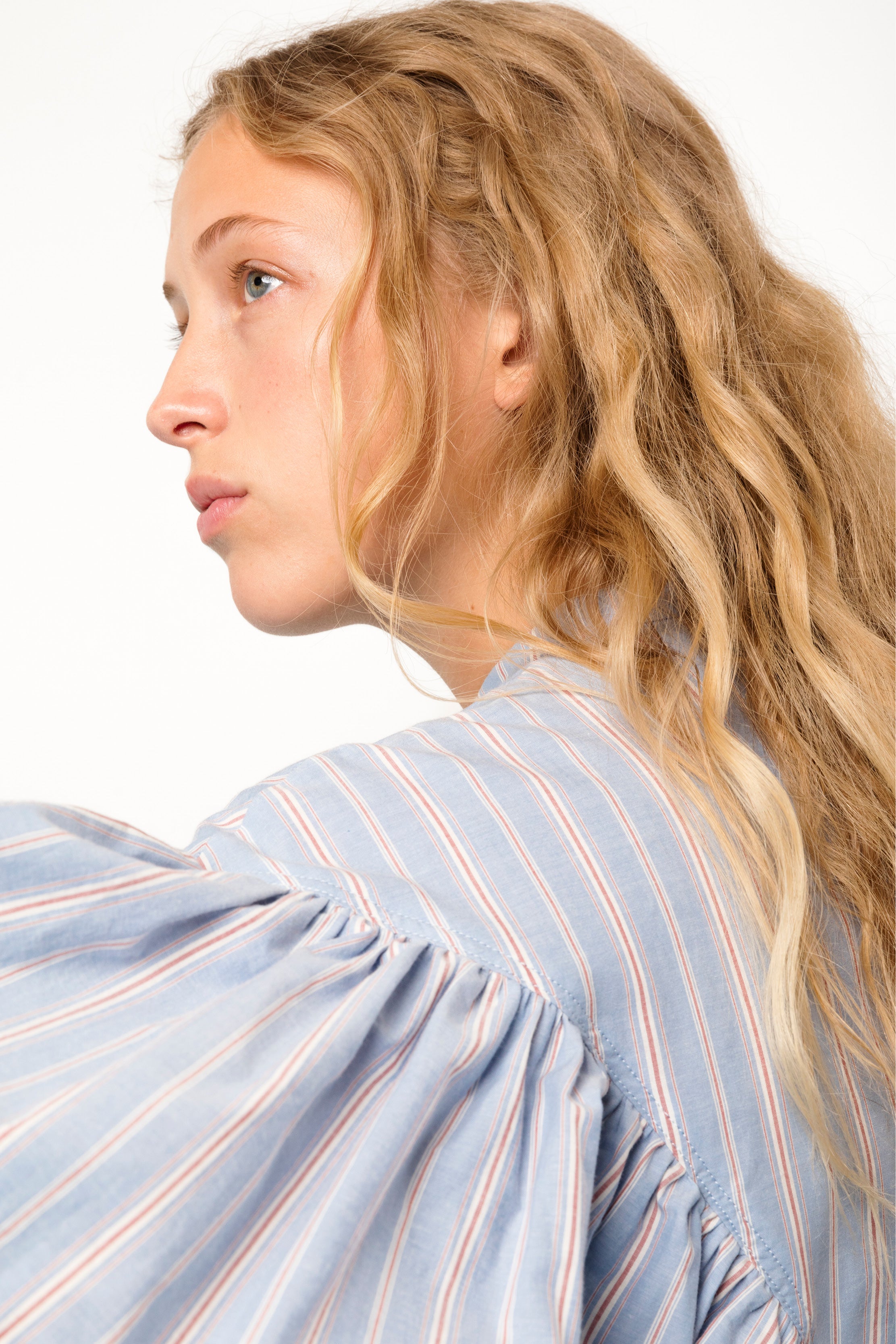 Woman in blue white and red striped blouse