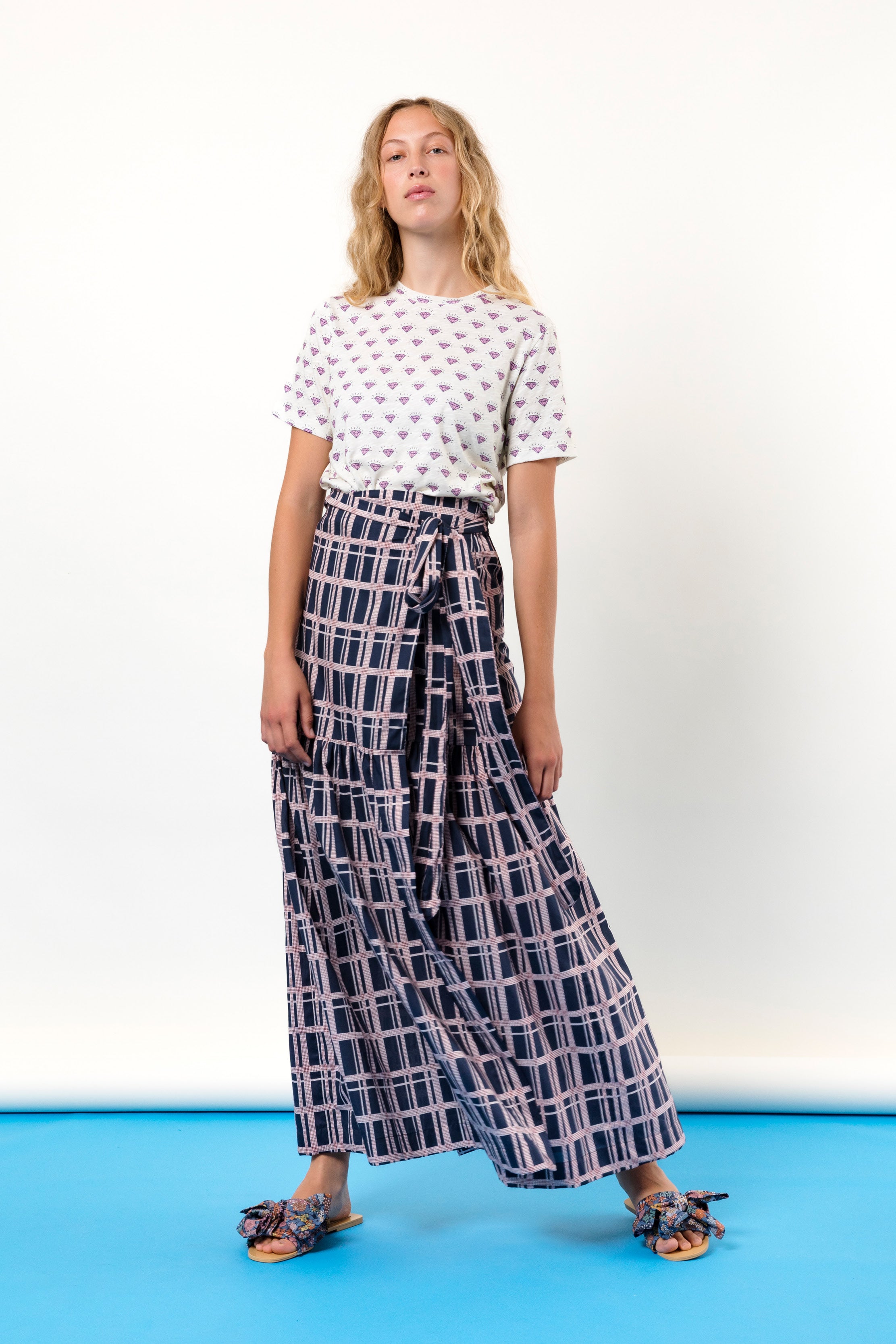 Woman in long wrap skirt with checked pattern and t-shirt