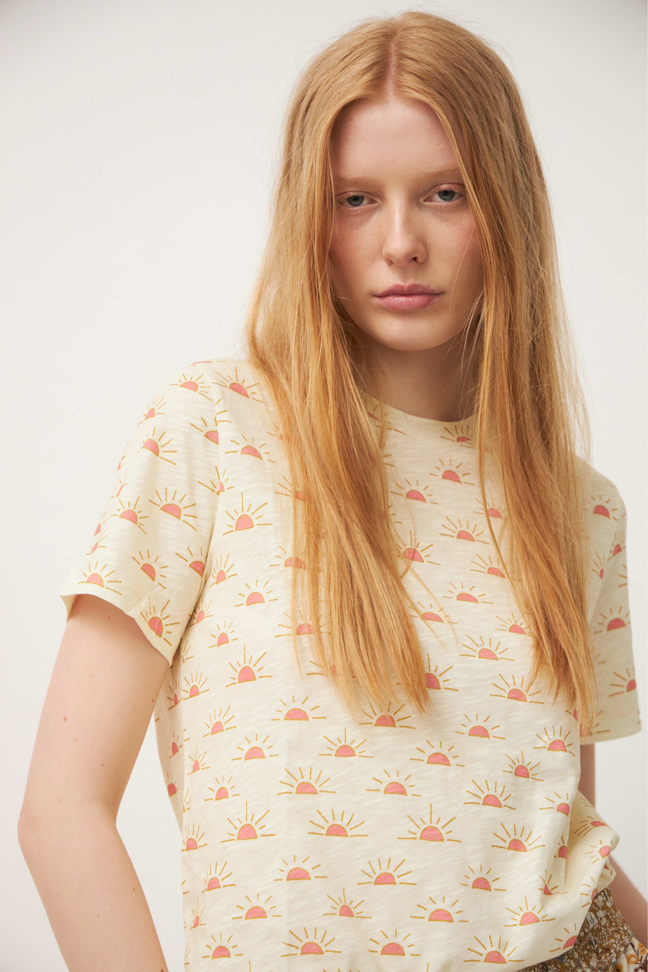 Woman in short sleeve white t-shirt with sunrise pattern