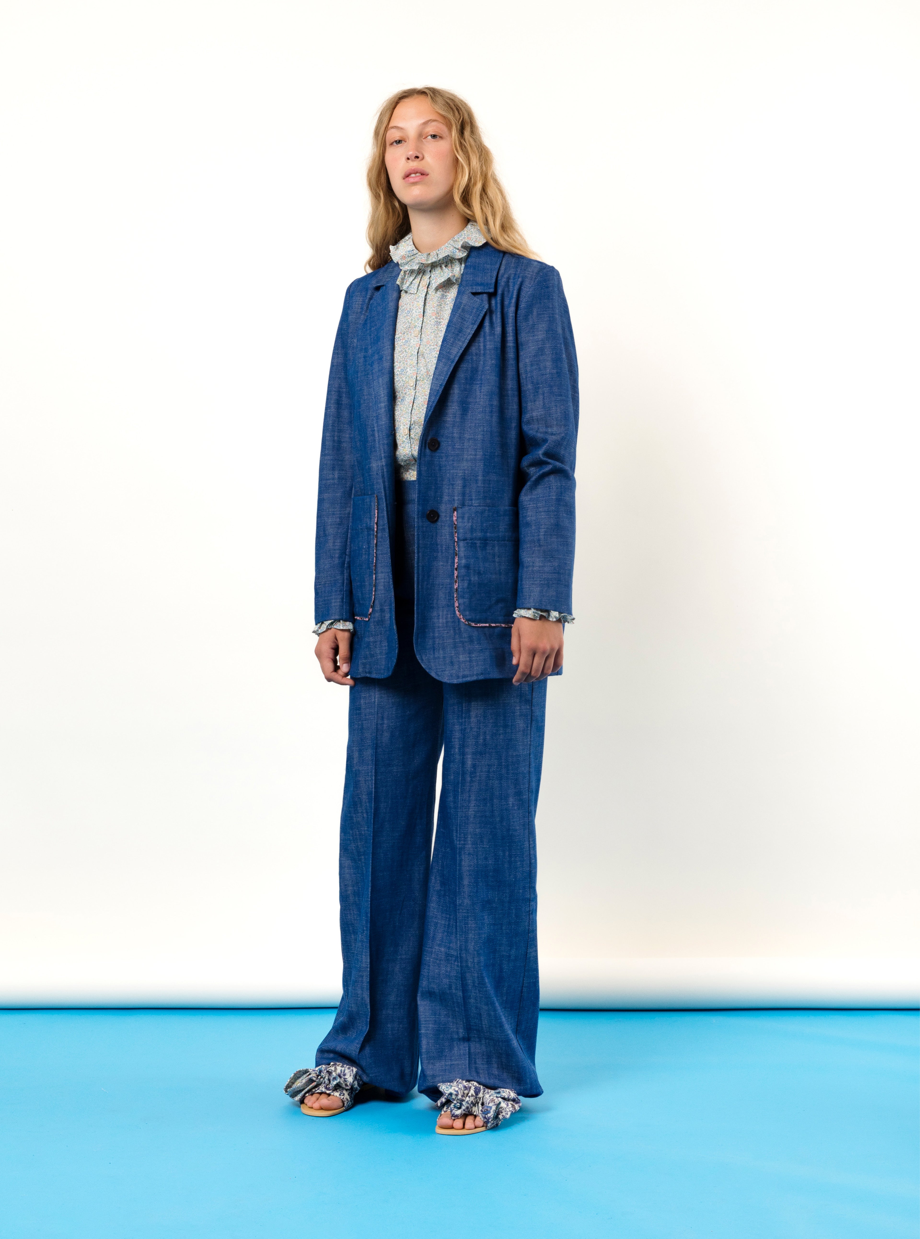 Woman in blue jeans costume and green blouse with ruffles