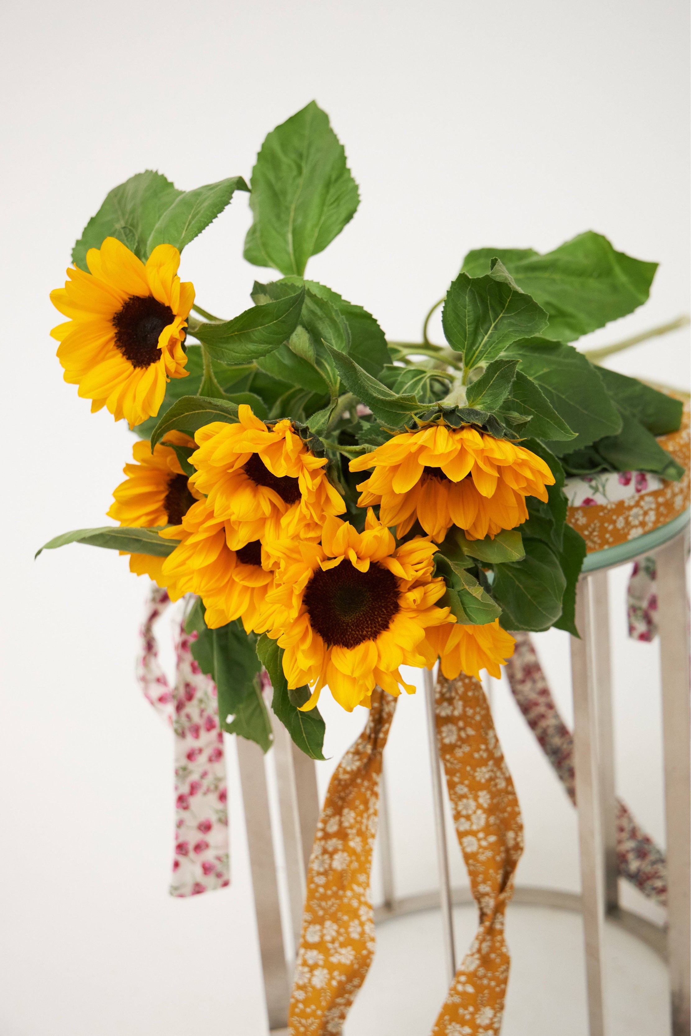 Vase with sunflowers and ribbons