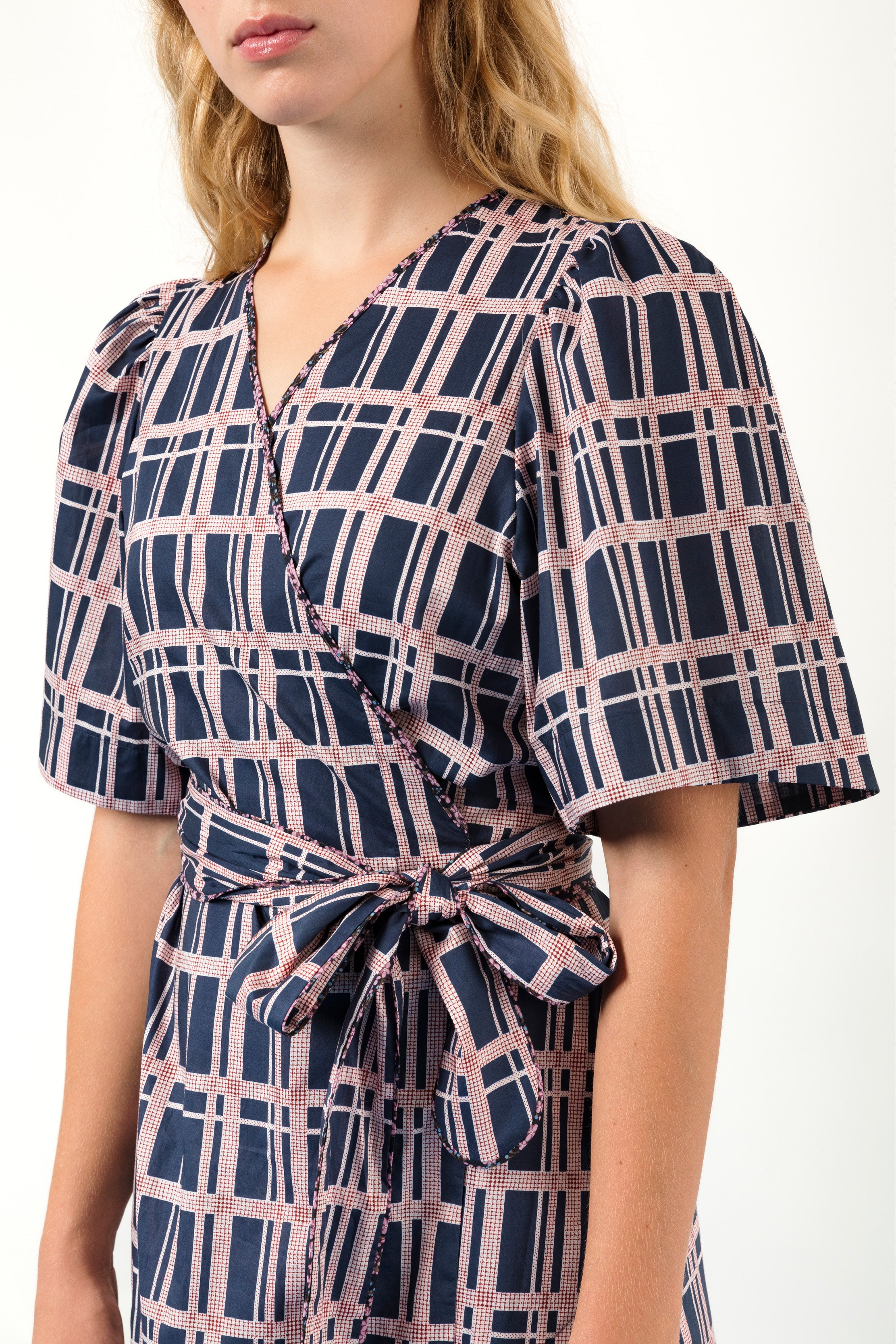 Woman in black and pink checked wrap dress in Liberty cotton with short sleeves