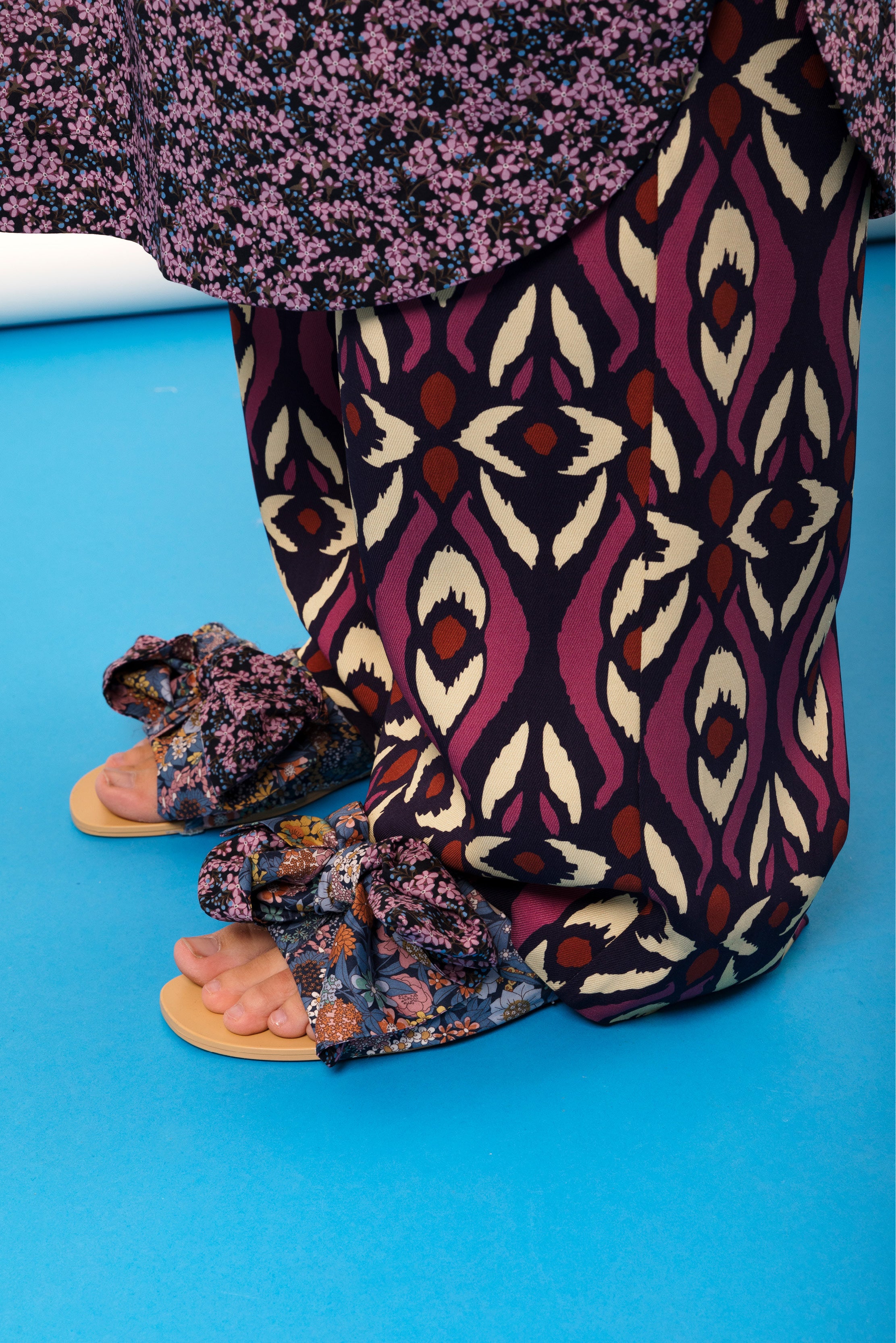 Women's viscose pants with ethnic pattern in red beige and black and sandals with flower patterned bows