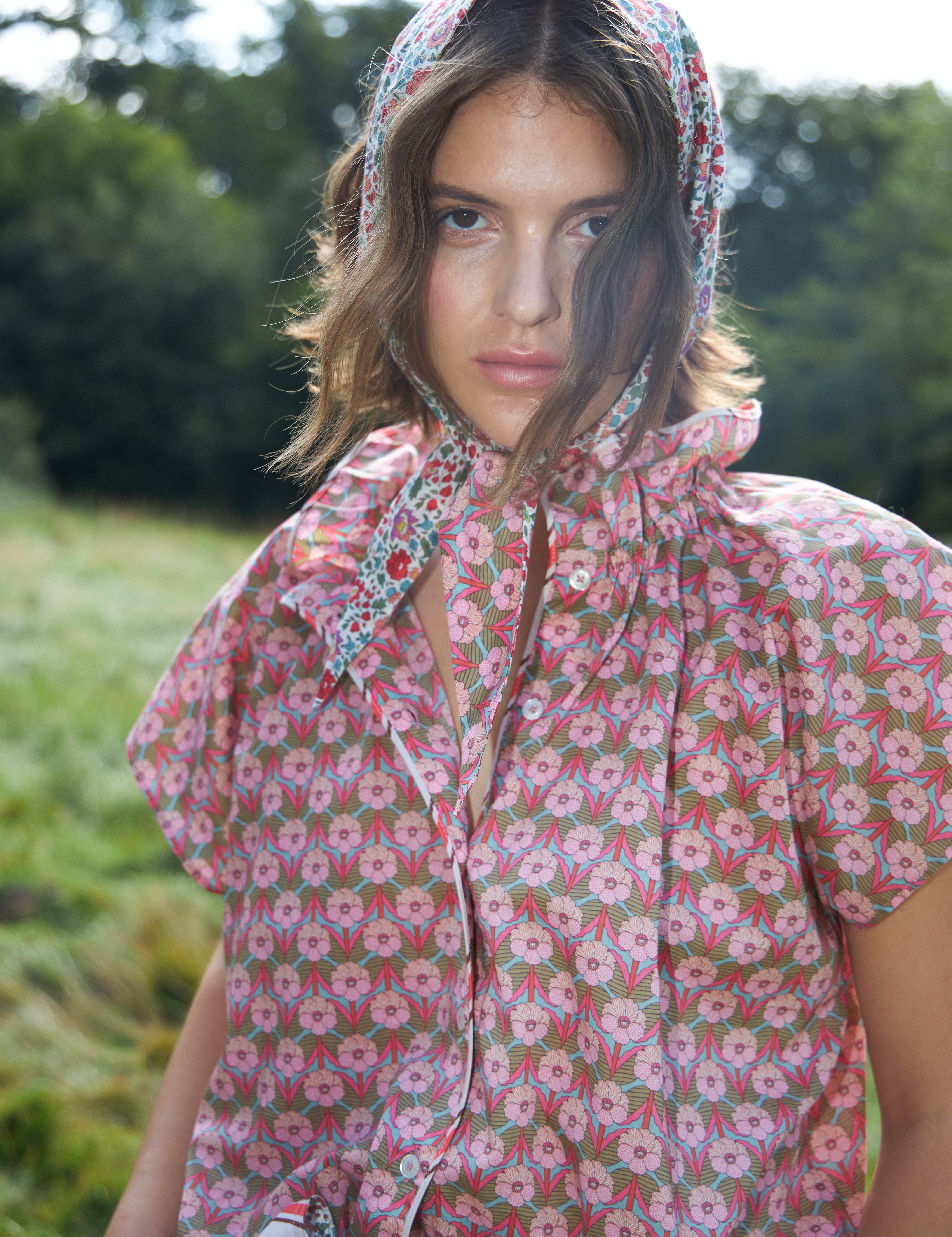 Woman in short sleeved blouse with pink floral print