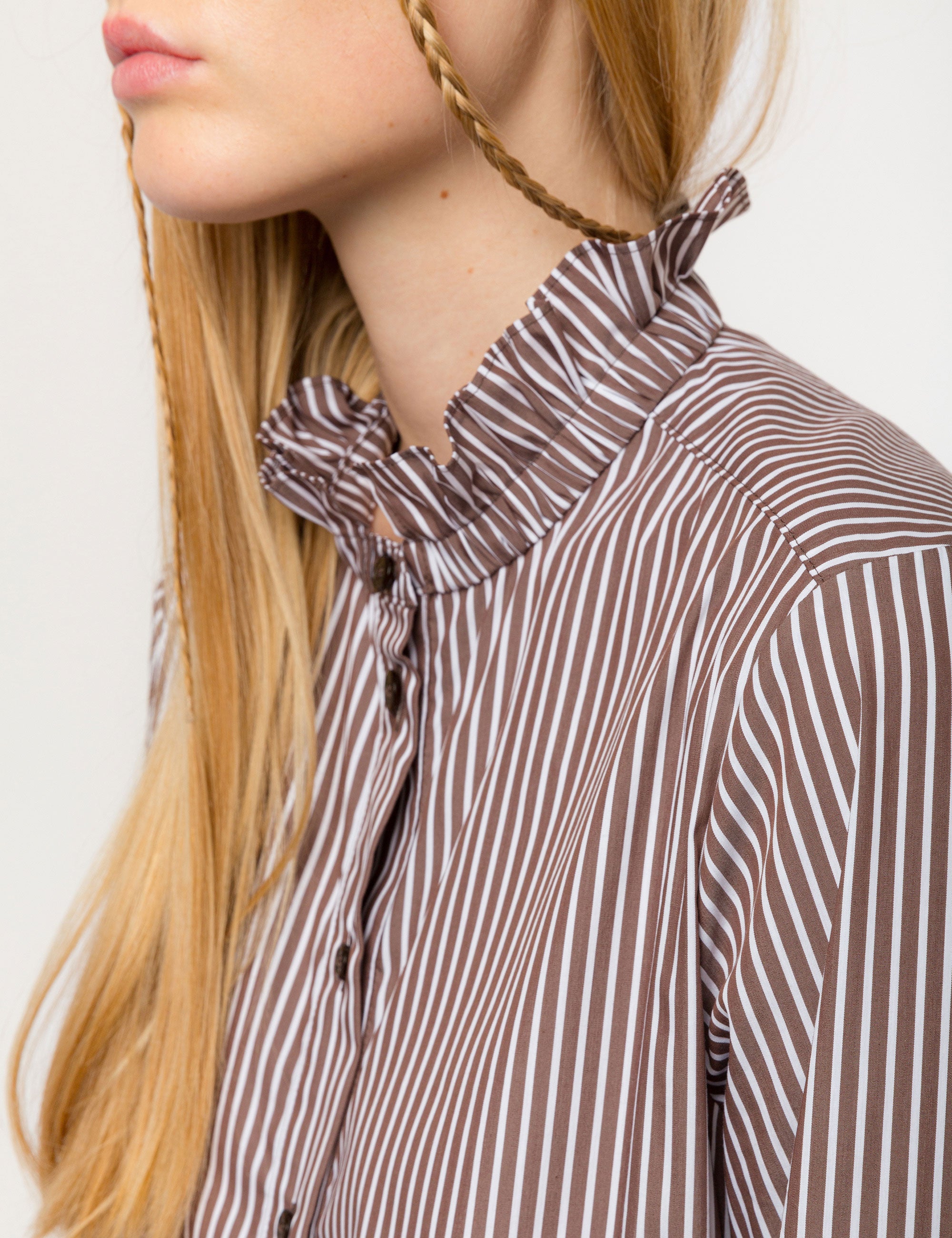 Woman in liberty cotton brown and white striped midi dress with long sleeves and ruffled collar