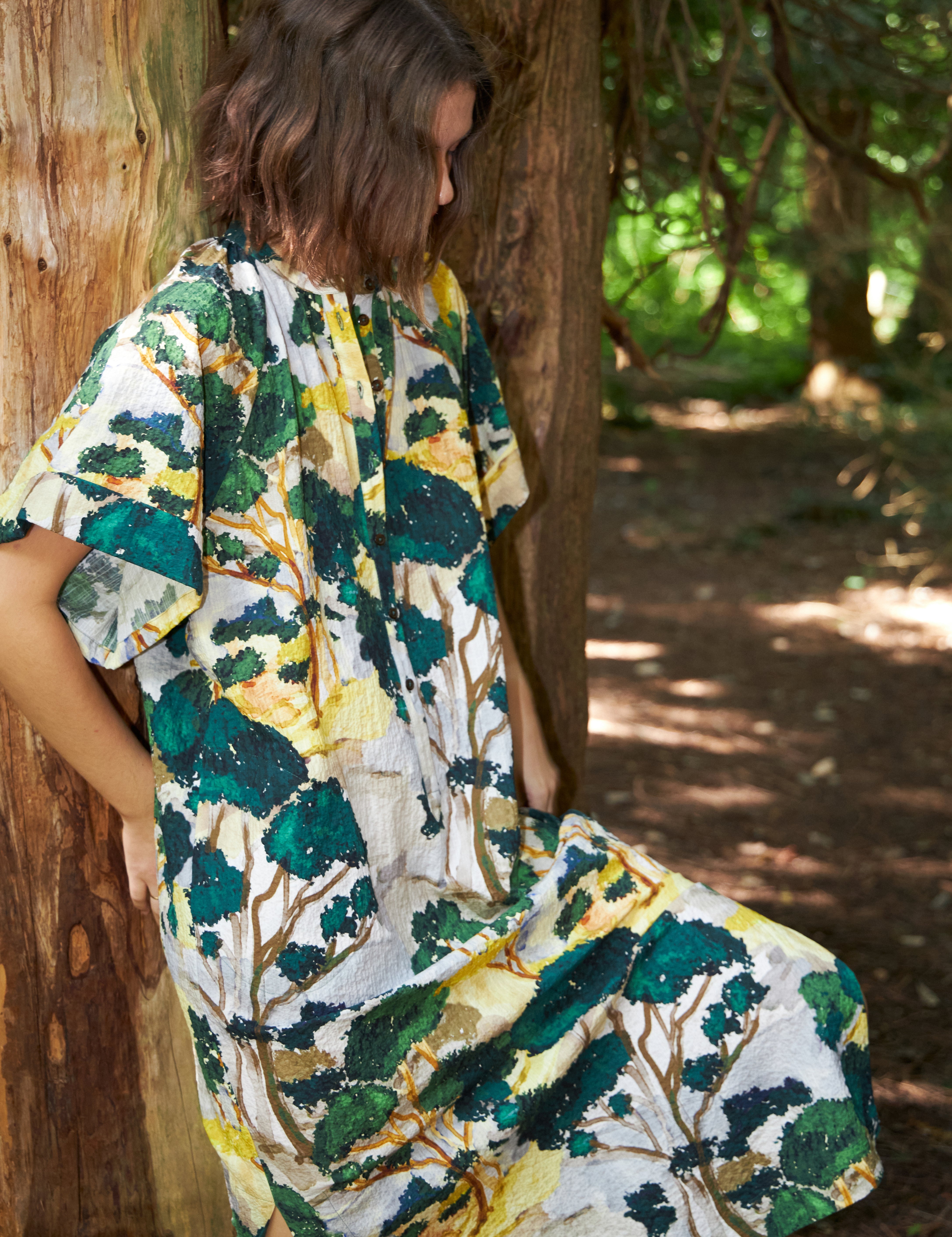 Woman in green white and yellow kimono dress with short sleves and buttons