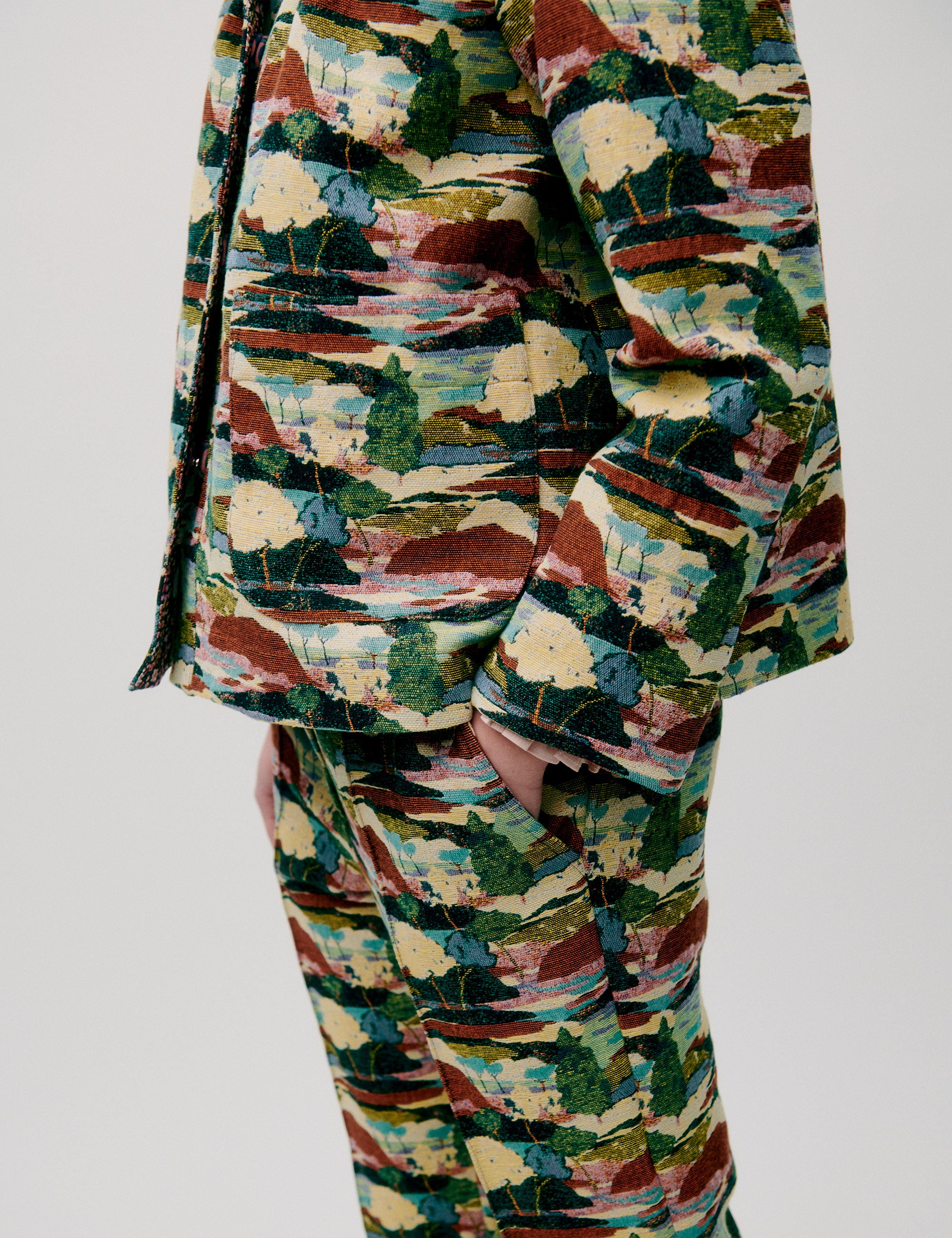 Woman in straight pants and jacket with artistic forest print