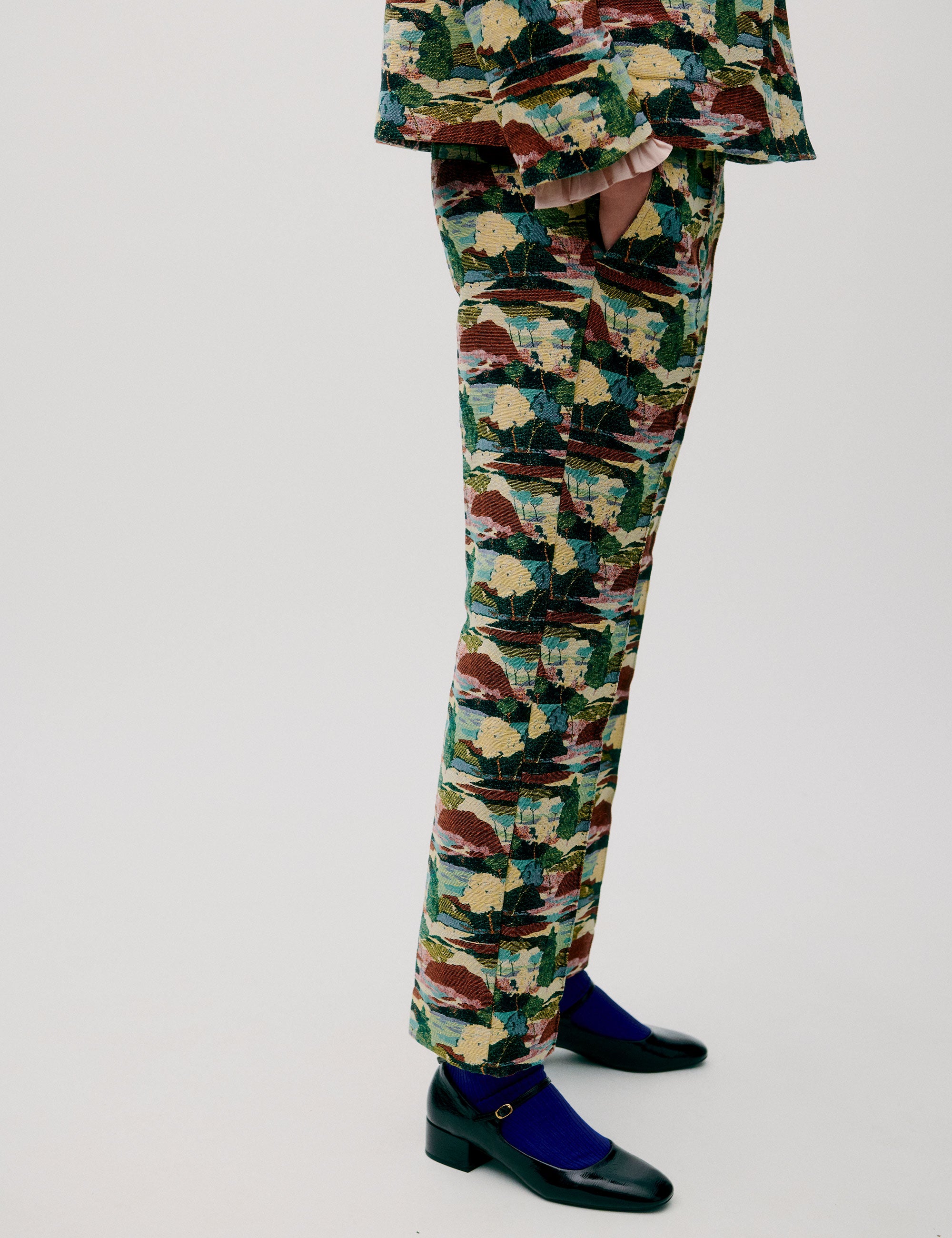 Side view of slim trousers with colorful painterly pattern and tapered leg