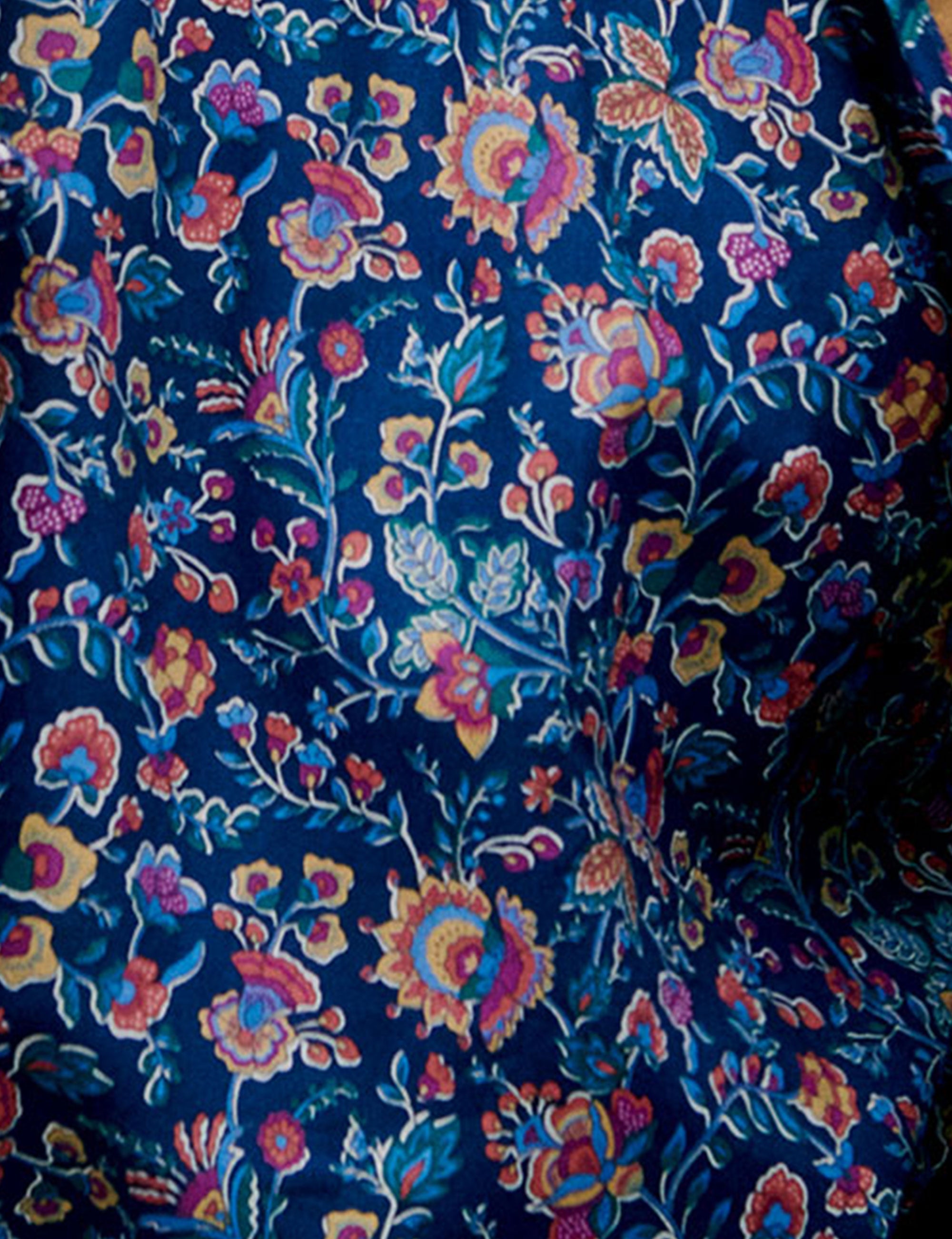 Close-up of floral blouse fabric and gathered waist detail