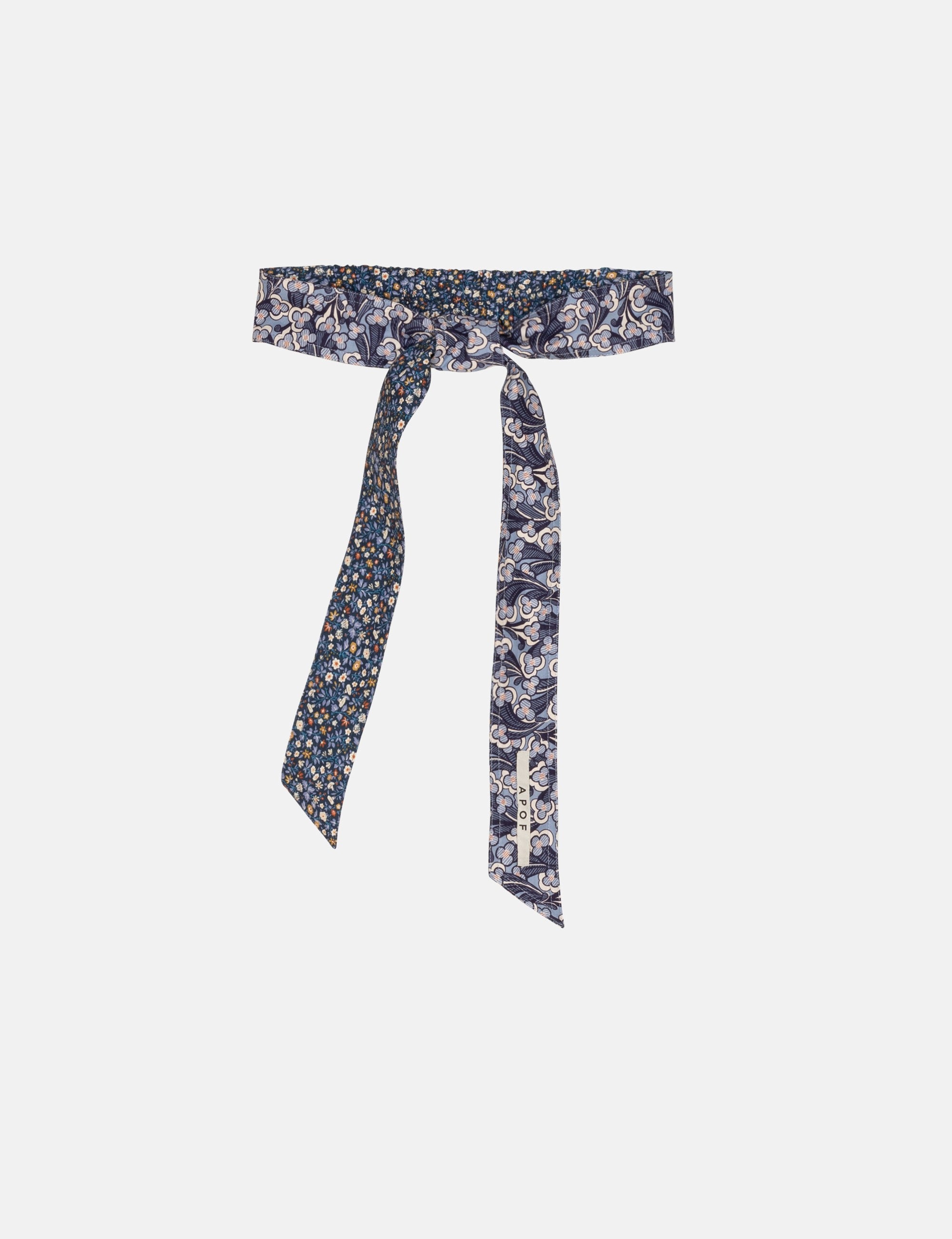 Floral patterned belt with a tie on a white background