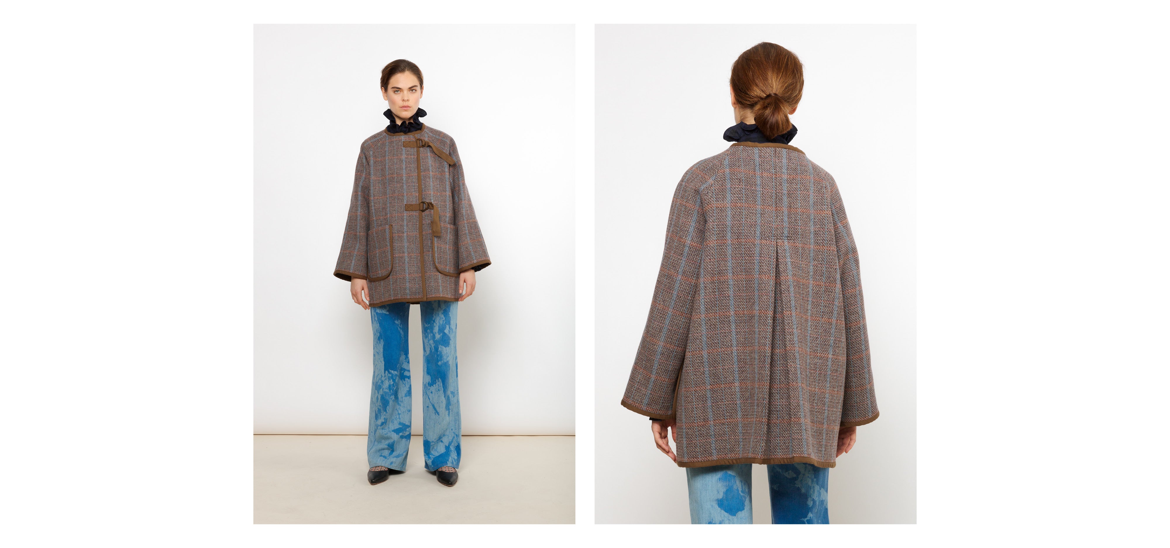 Woman in blue pants, short brown wool coat with check pattern and black blouse with frilled collar