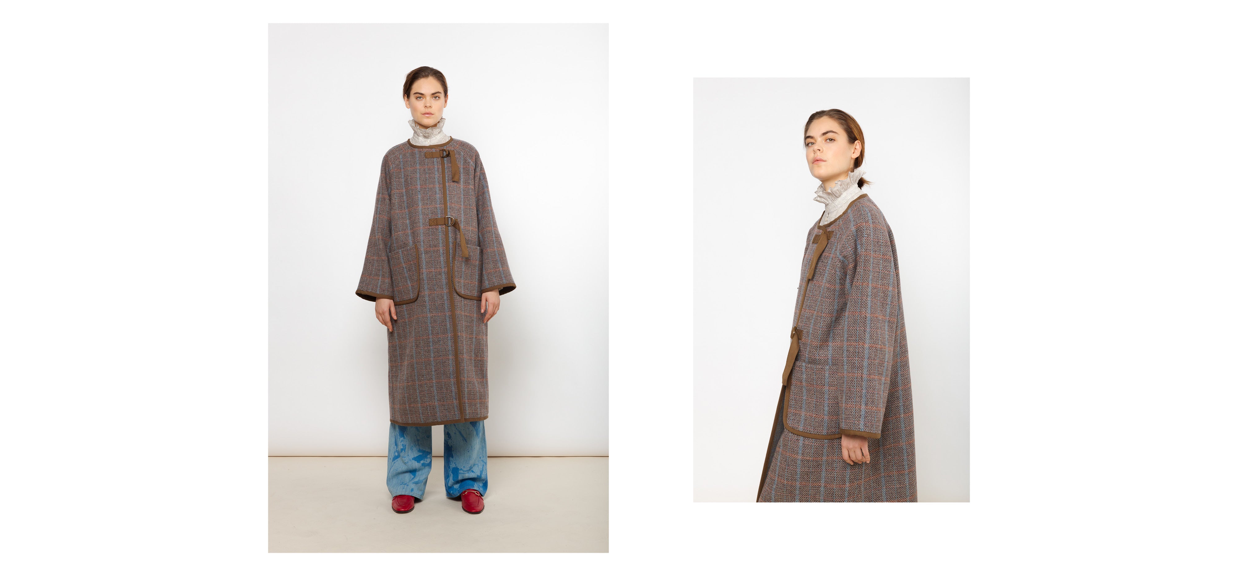 Woman in blue pants and long brown wool coat with check pattern and pockets
