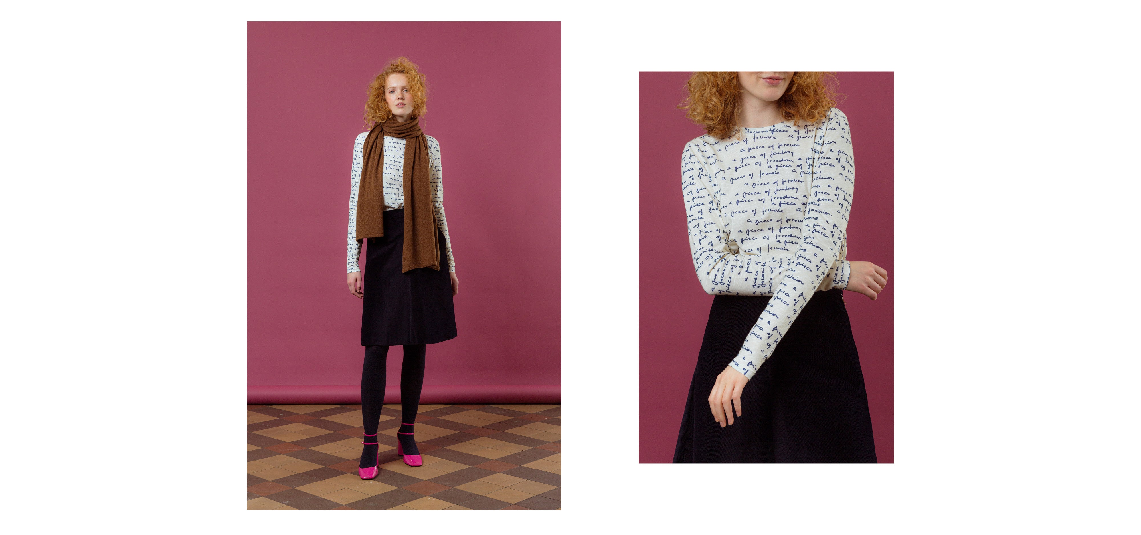 Woman in black midi skirt, brown scarf and long sleeved t-shirt with text print