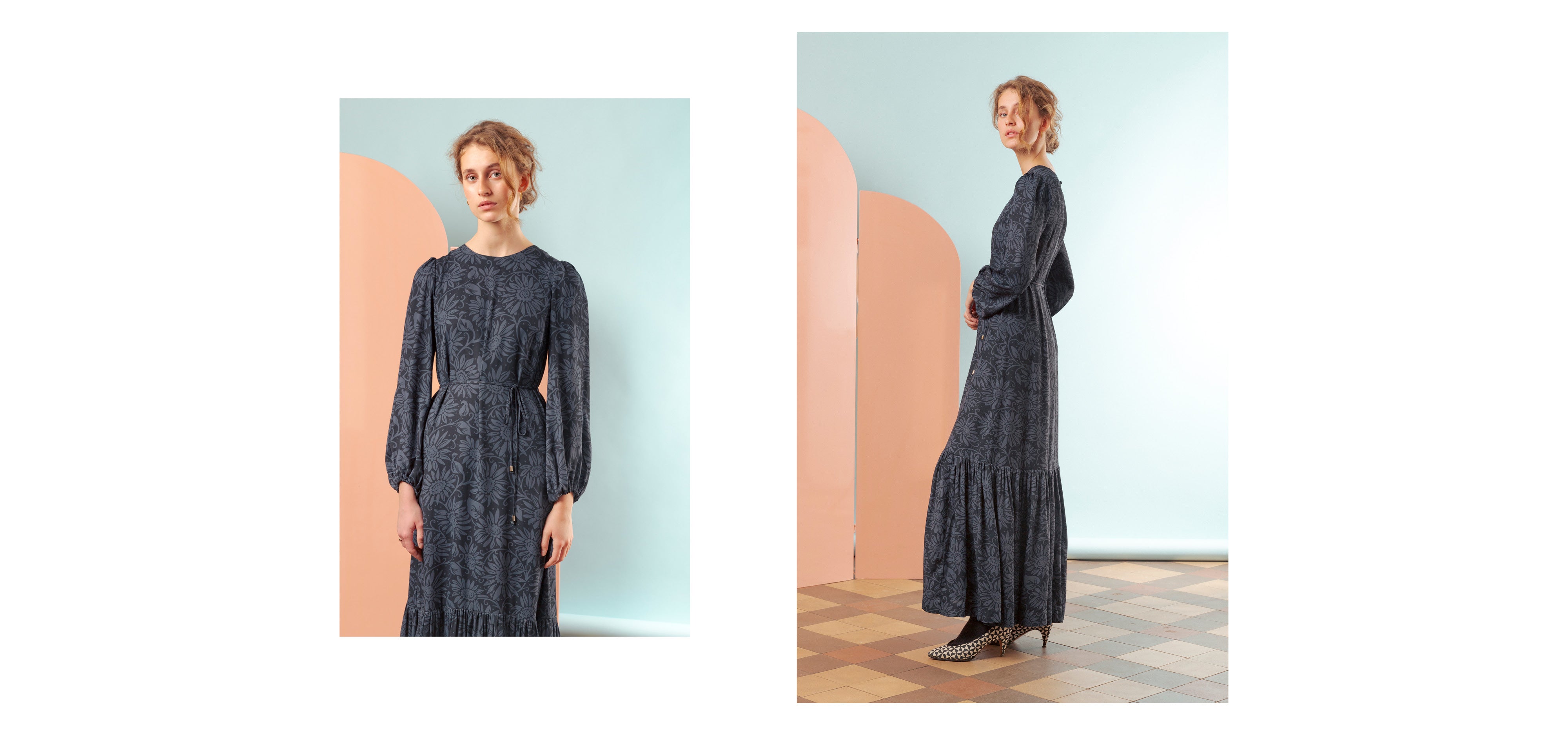 Woman in dark flower patterned maxi dress with long puffed sleeves and belt