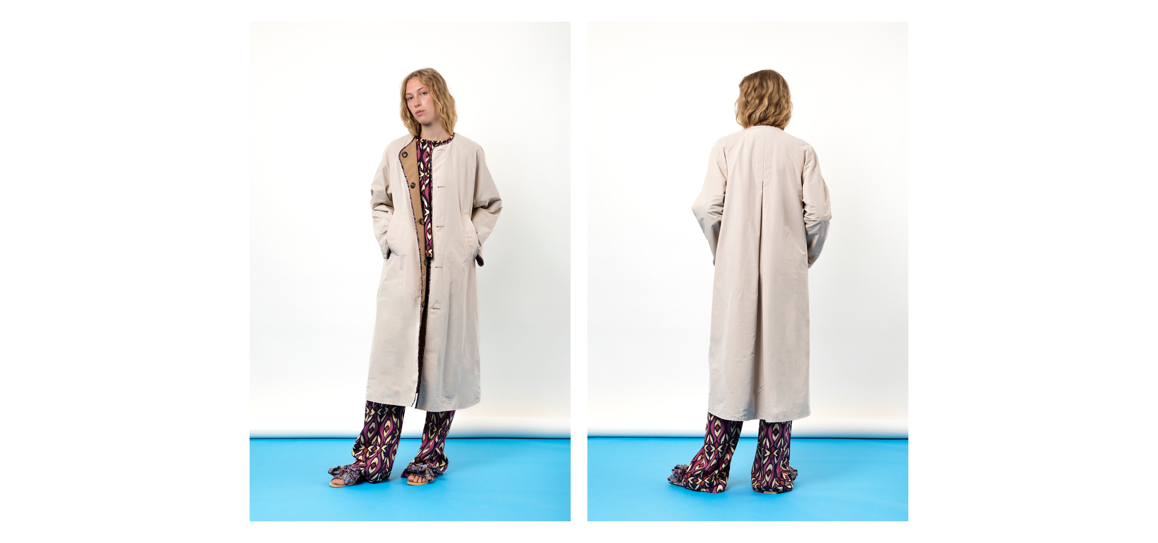 Woman in long off-white coat with buttons and pockets and multi-colored pants and shirt