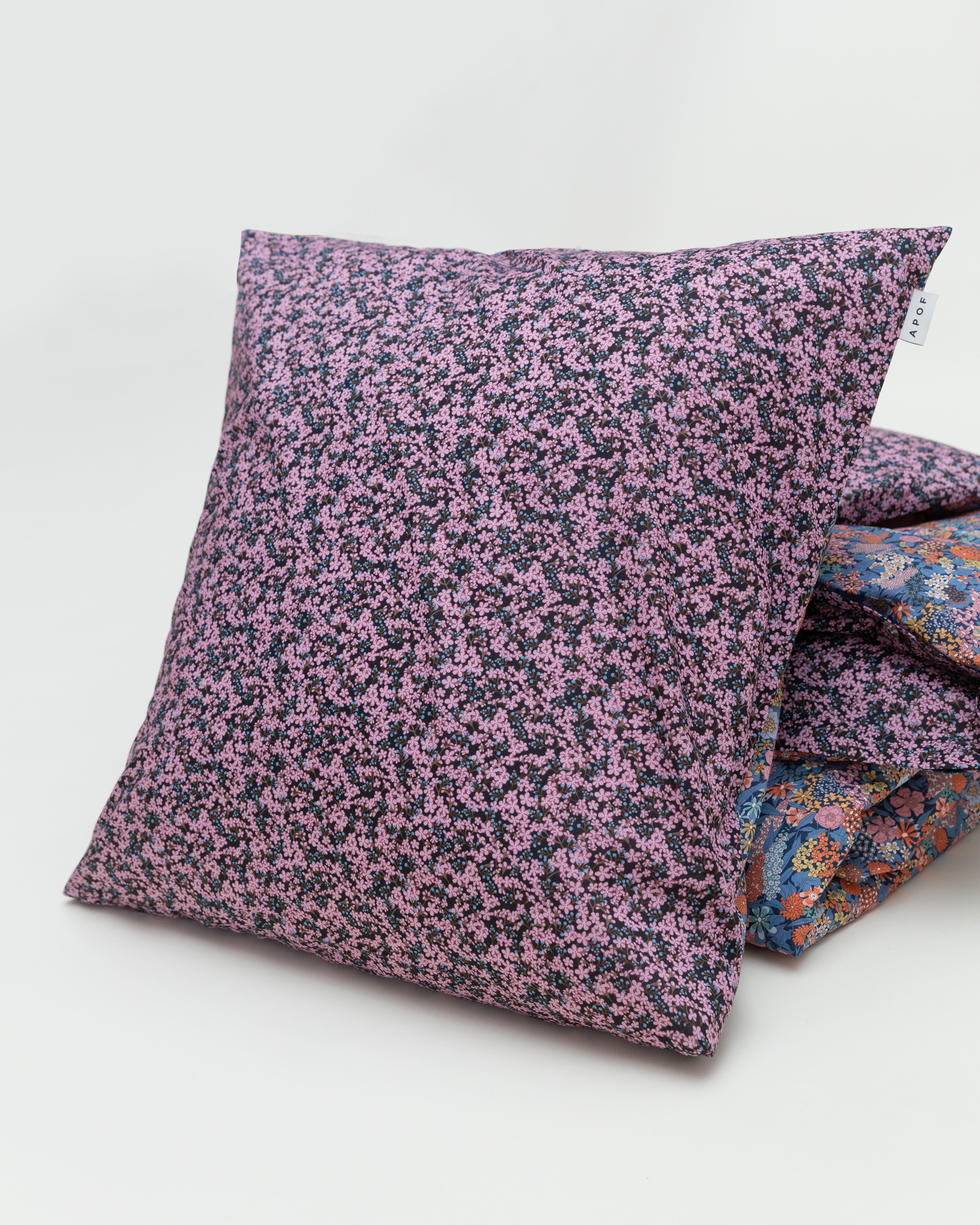 Pillow cover with purple and multi colored flower pattern