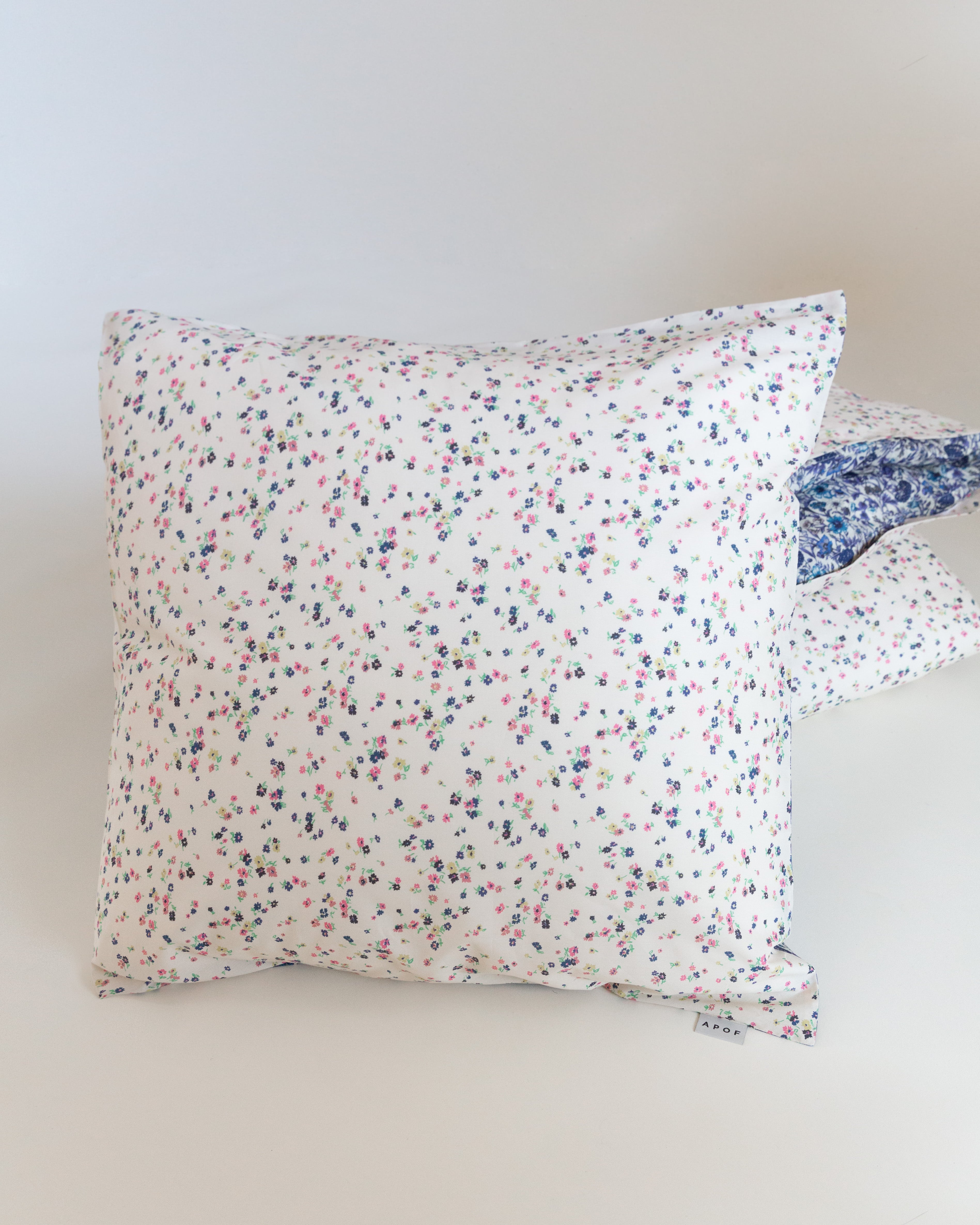 White pillow cover with multi colored and flower pattern