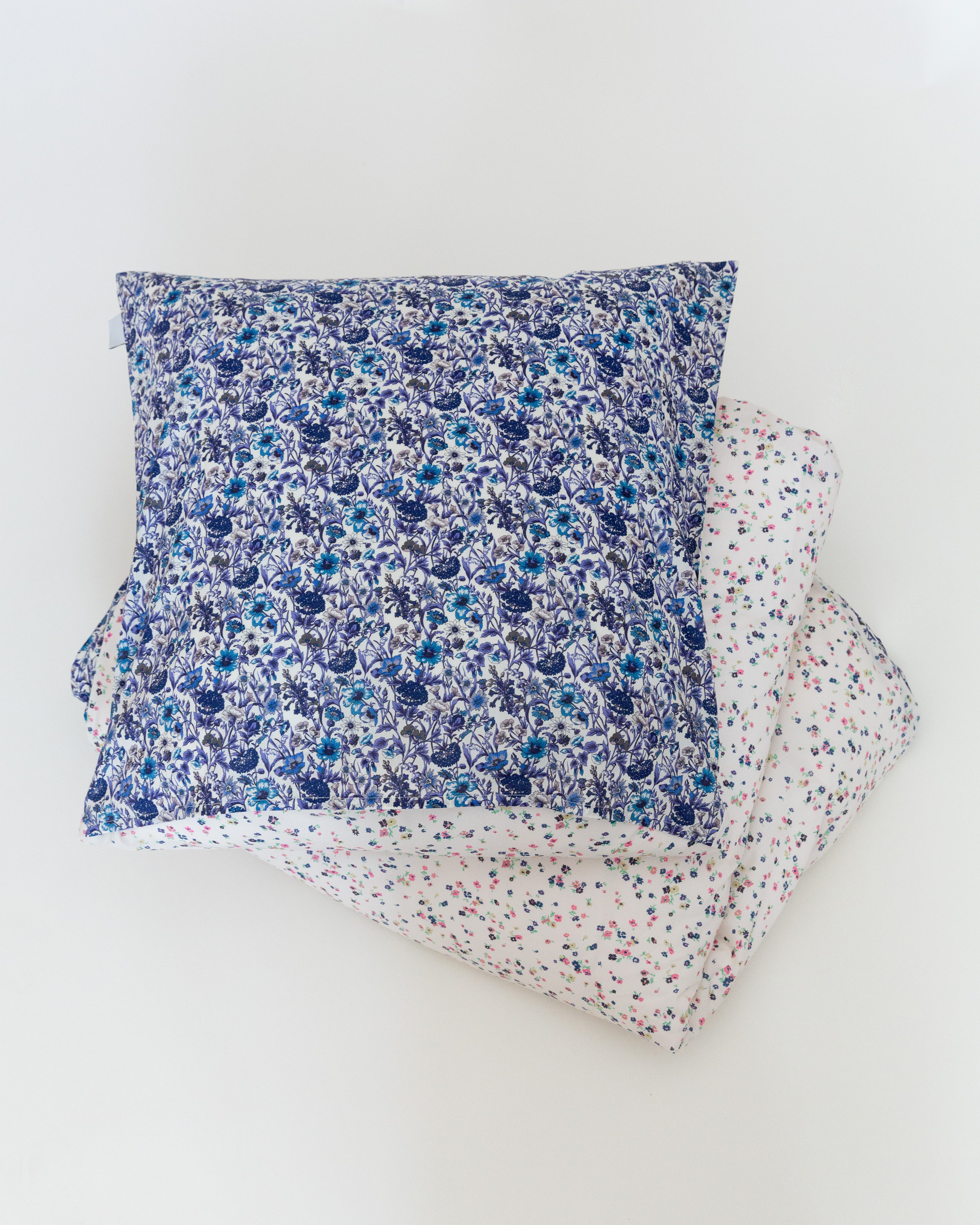 Pillow cover with multi colored and blue flower pattern