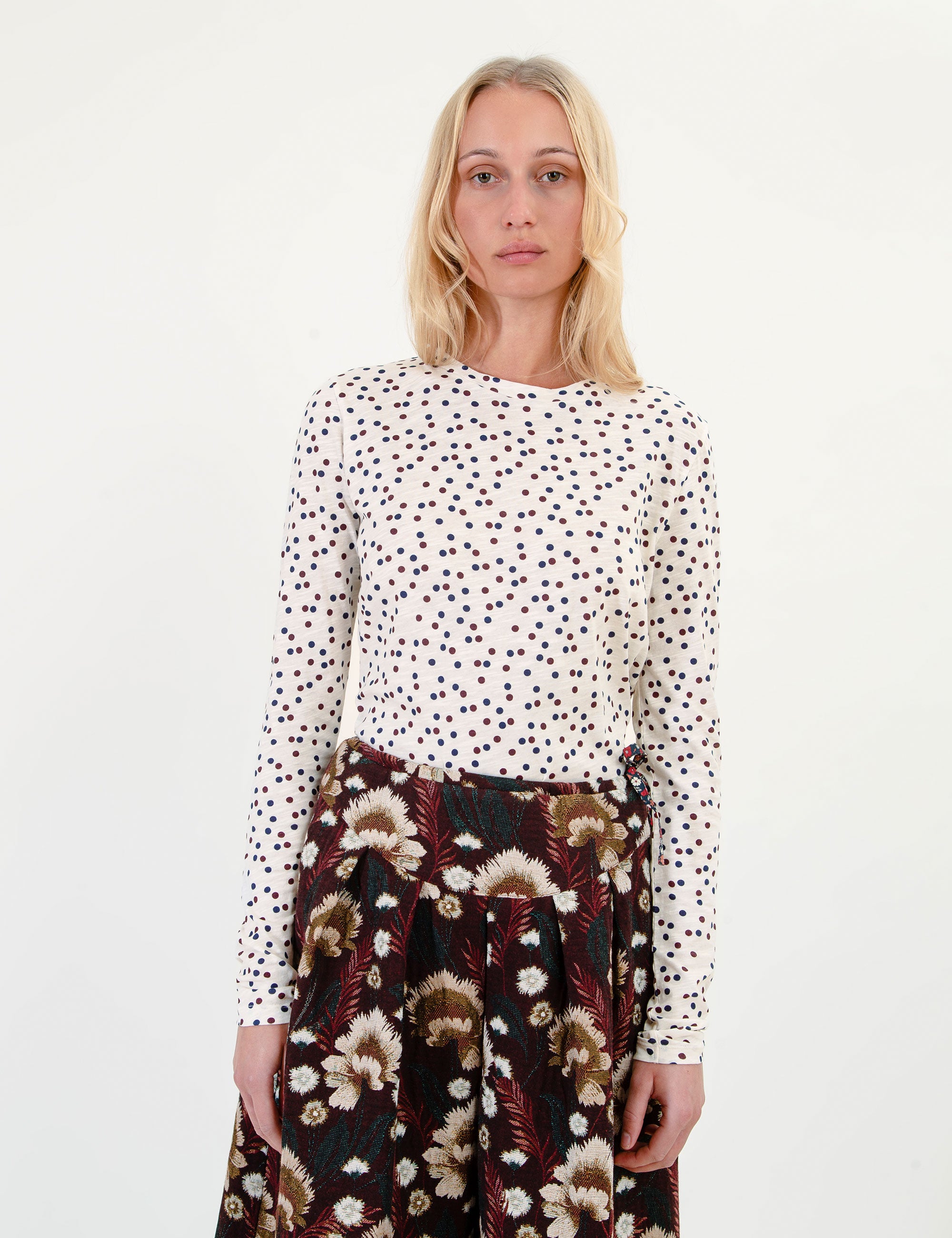 White long-sleeve crew-neck t-shirt with scattered dark red dots