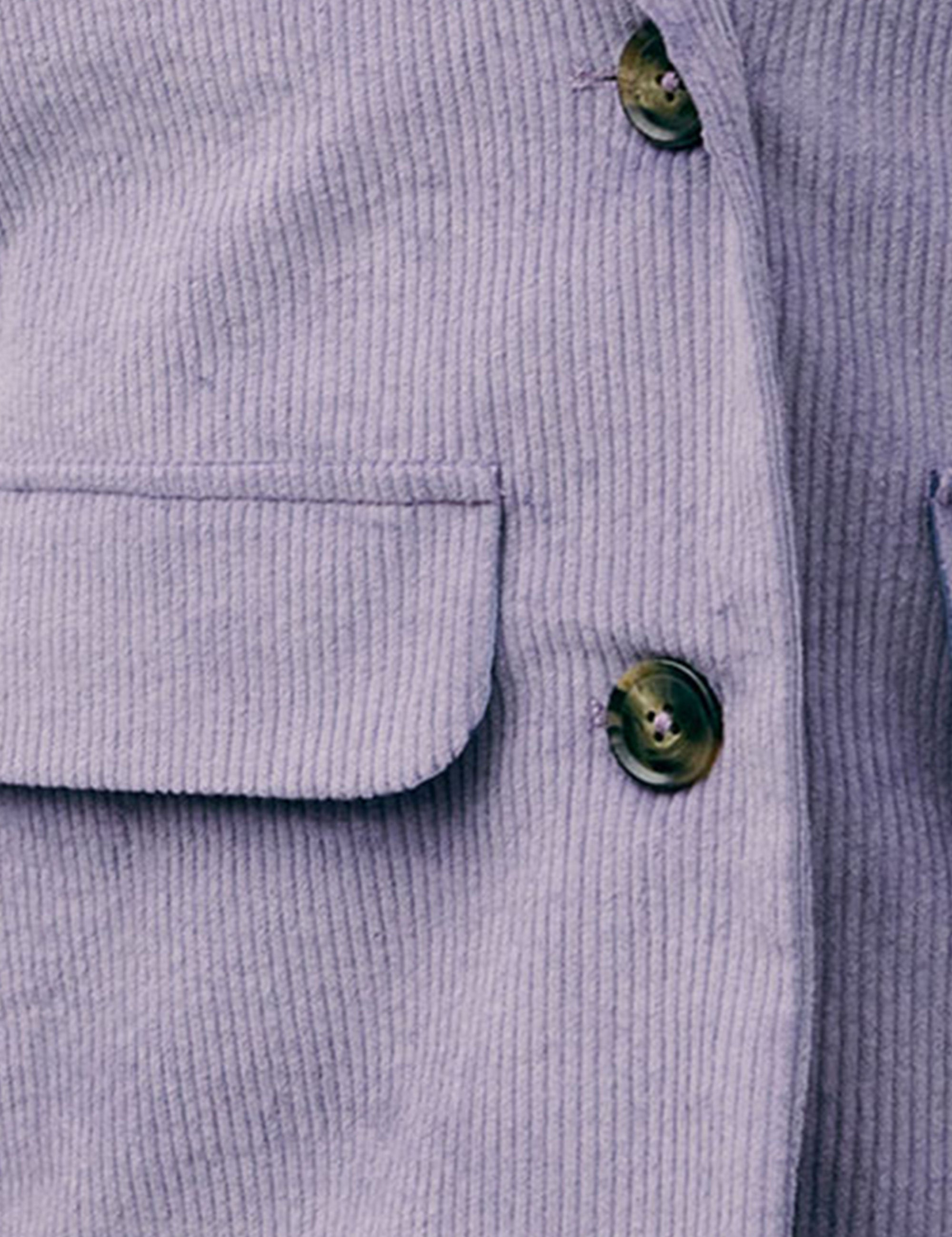 Close-up of lilac corduroy fabric showing flap pocket and button detail