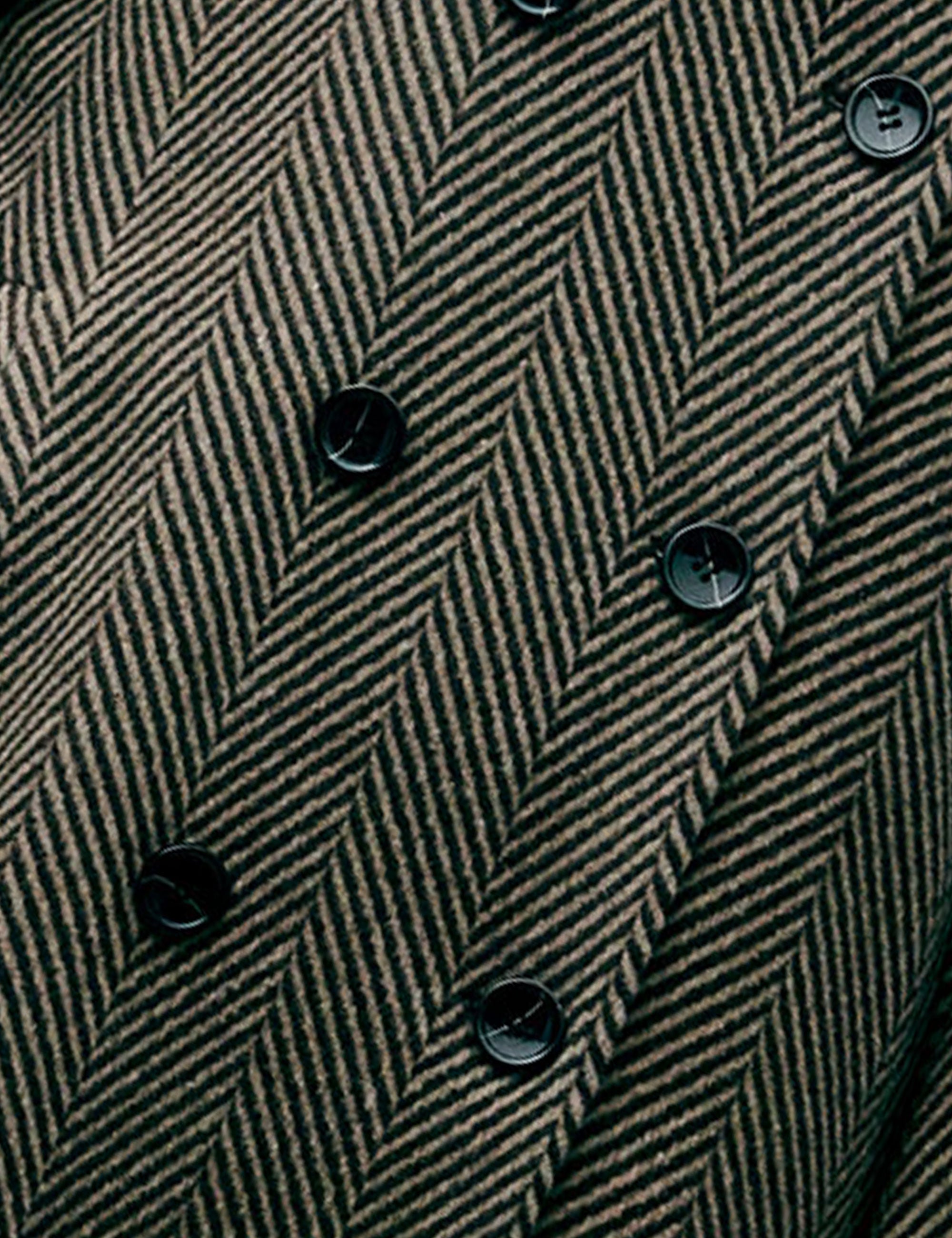 Close-up of a herringbone-patterned jacket with black buttons