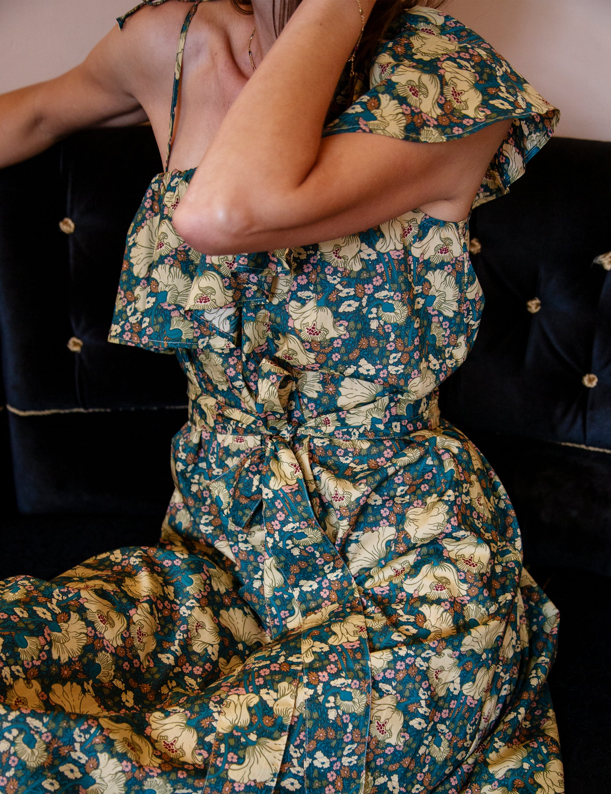 Woman wearing a green floral dress with a dark background