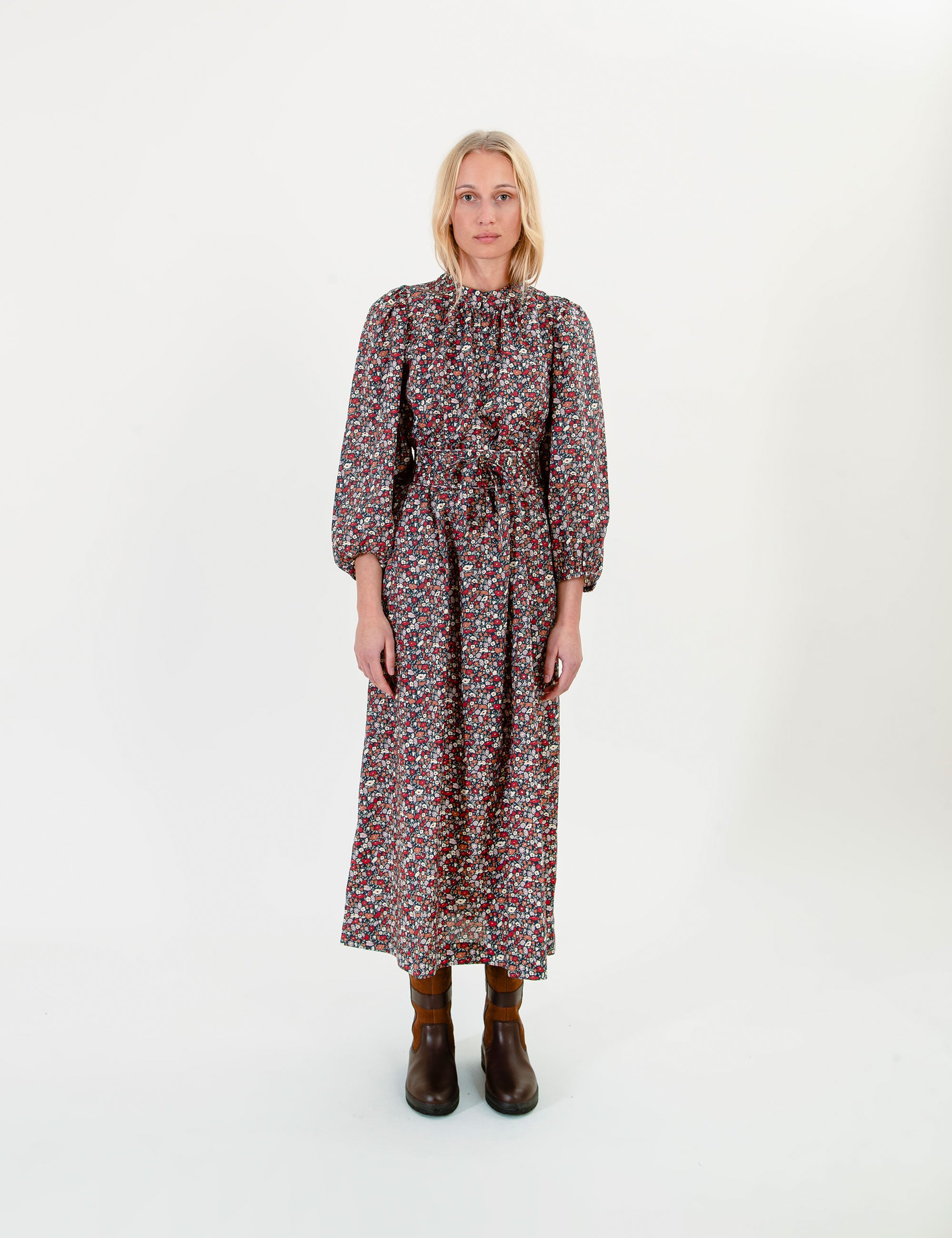 Woman wearing a floral maxi dress on a white background