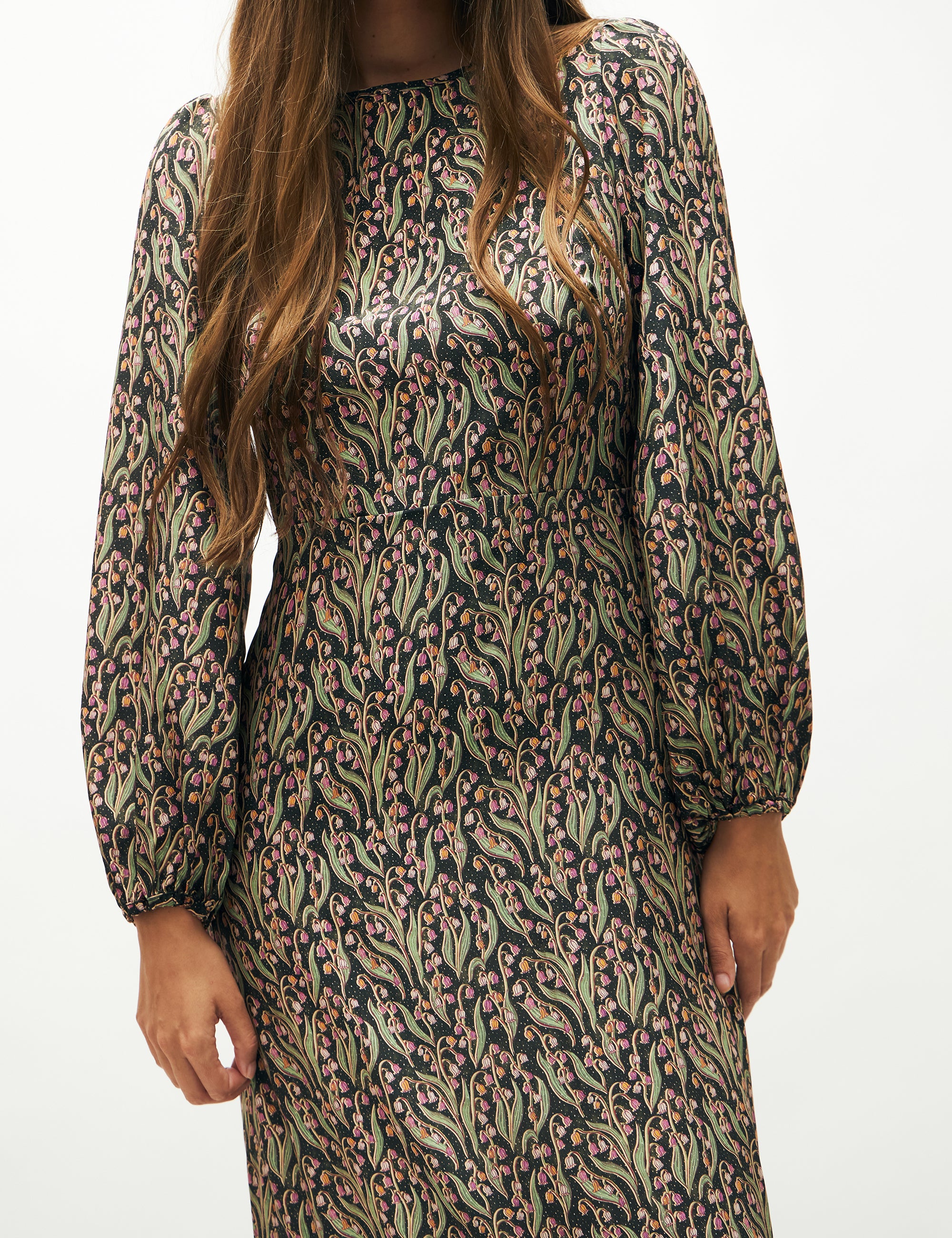 Woman in green and pink flower patterned maxi dress with long puff sleeves