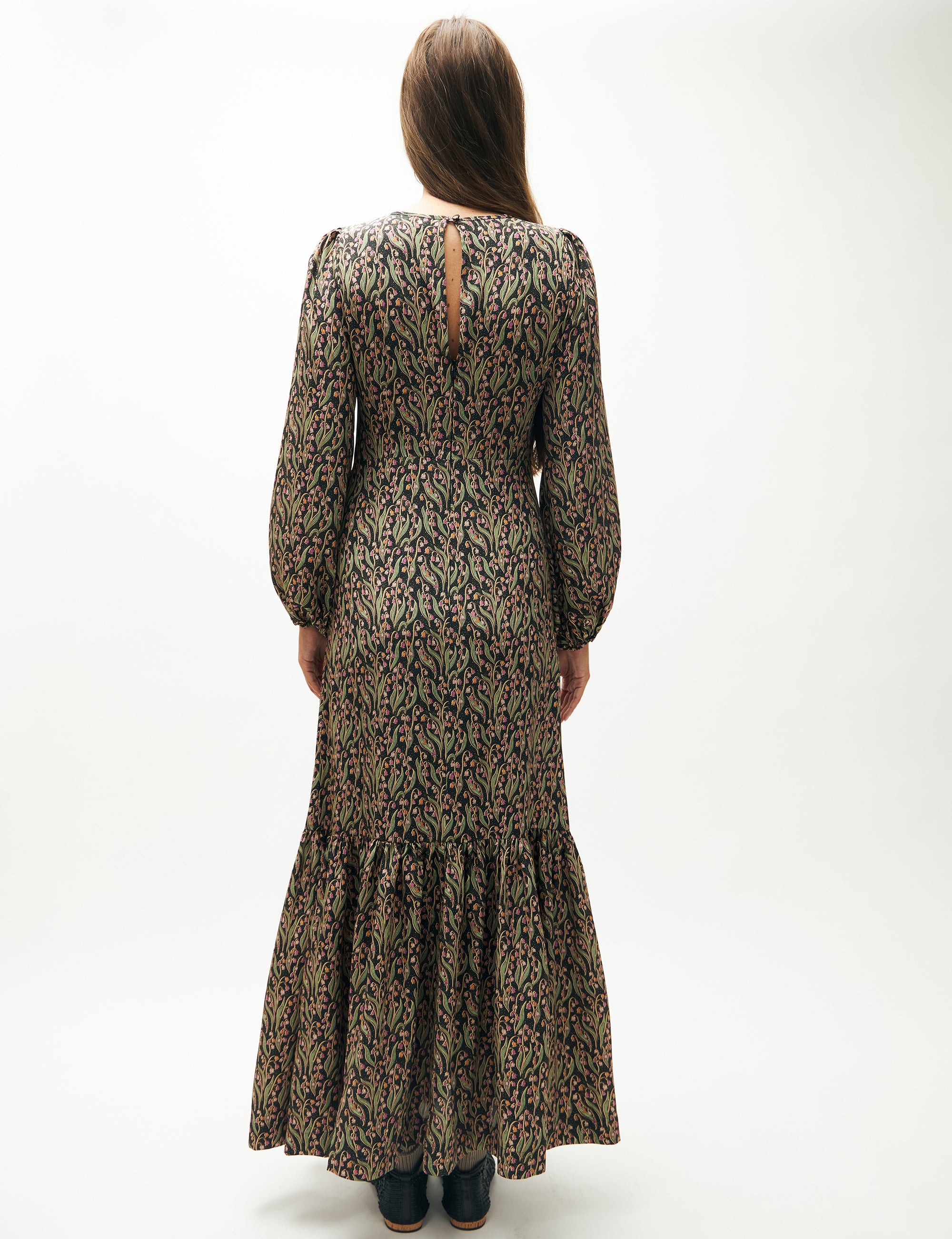 Woman in green and pink flower patterned maxi dress with long puff sleeves