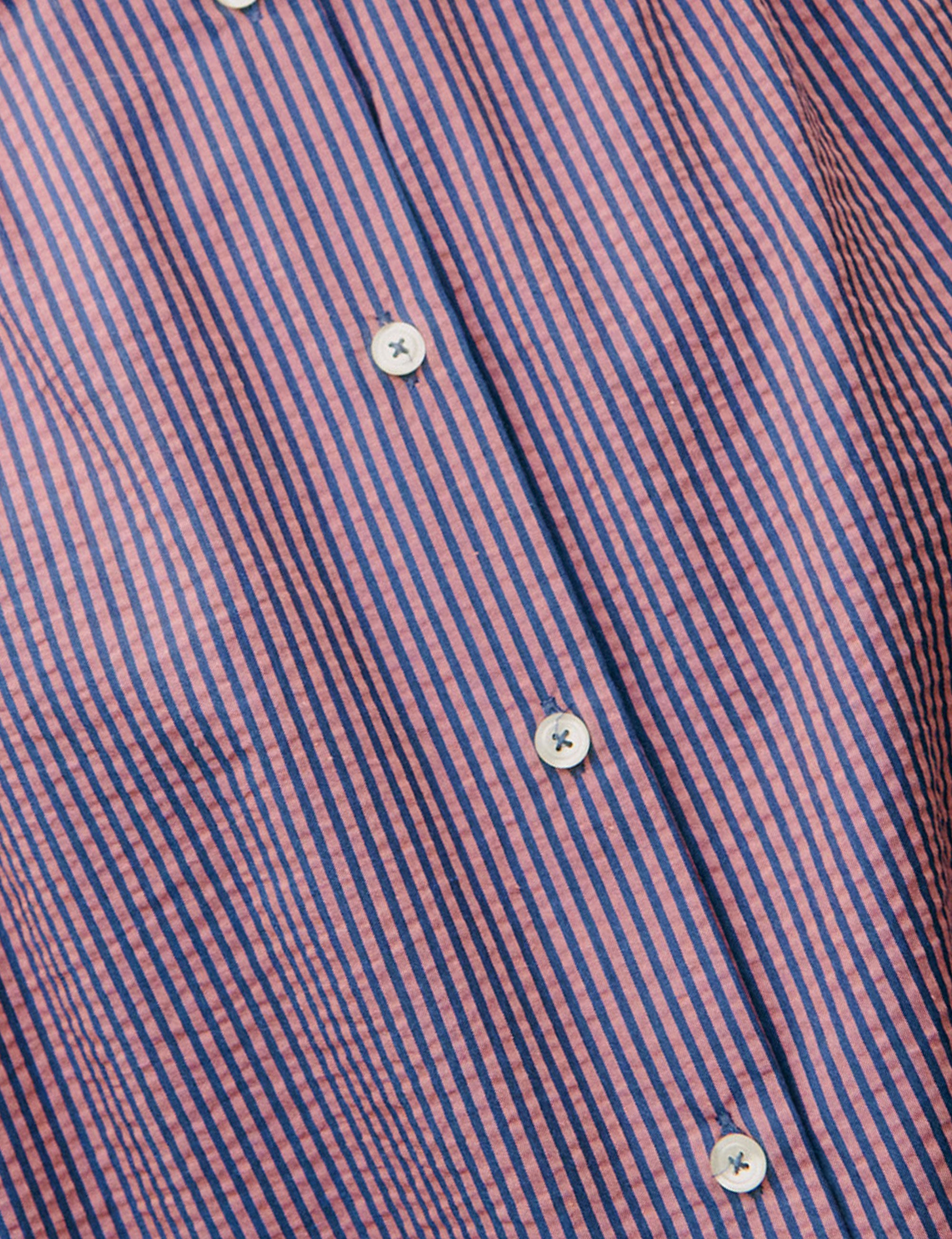 Pink and blue striped fabric with white buttons