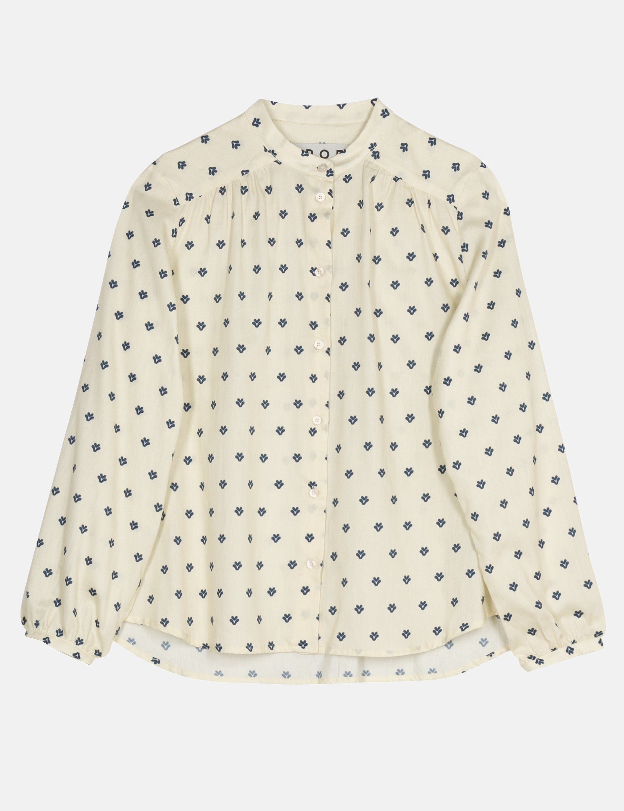 White long sleeve blouse with small blue floral pattern on a white background