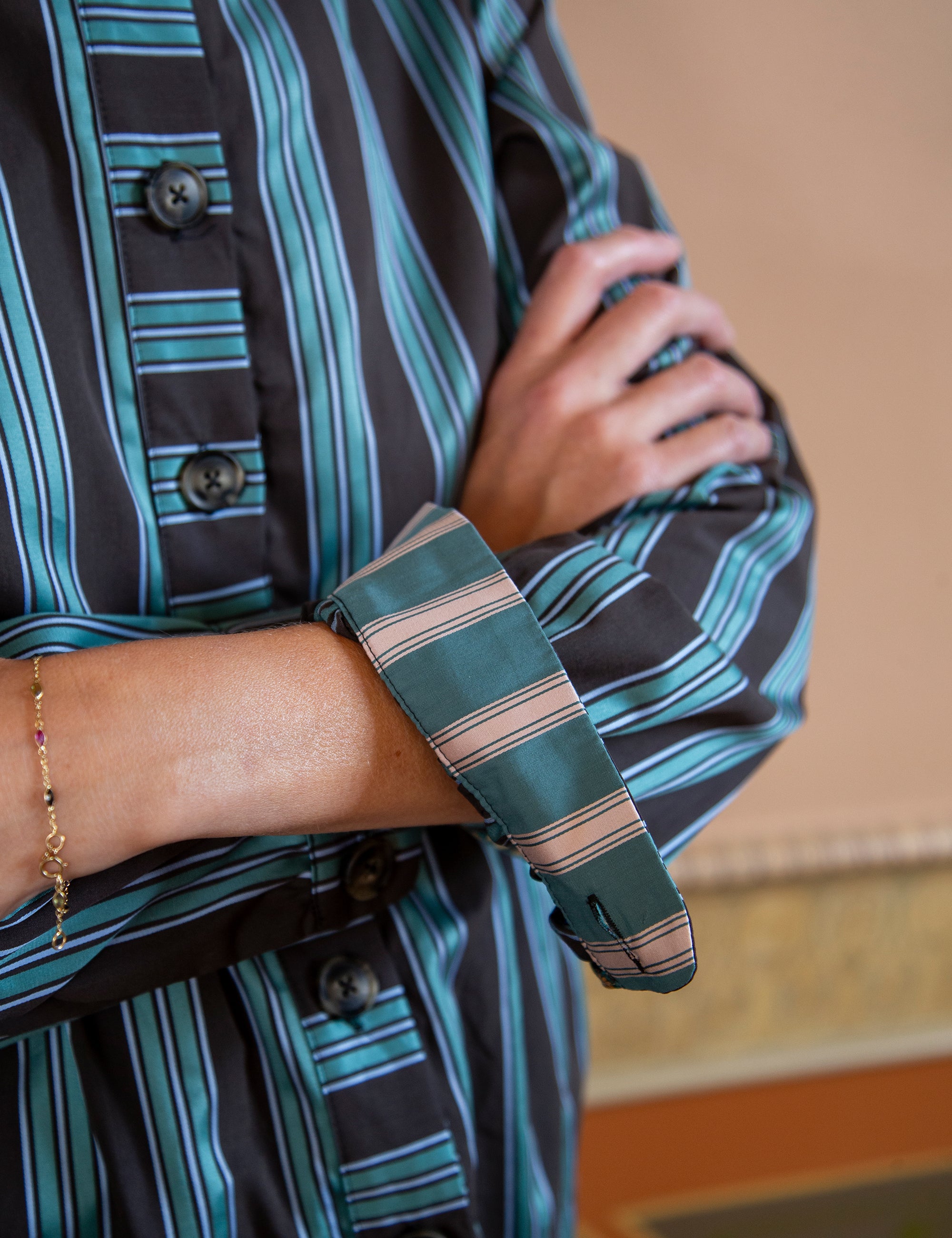 Woman wearing a striped jacket with a striped arm sleeve