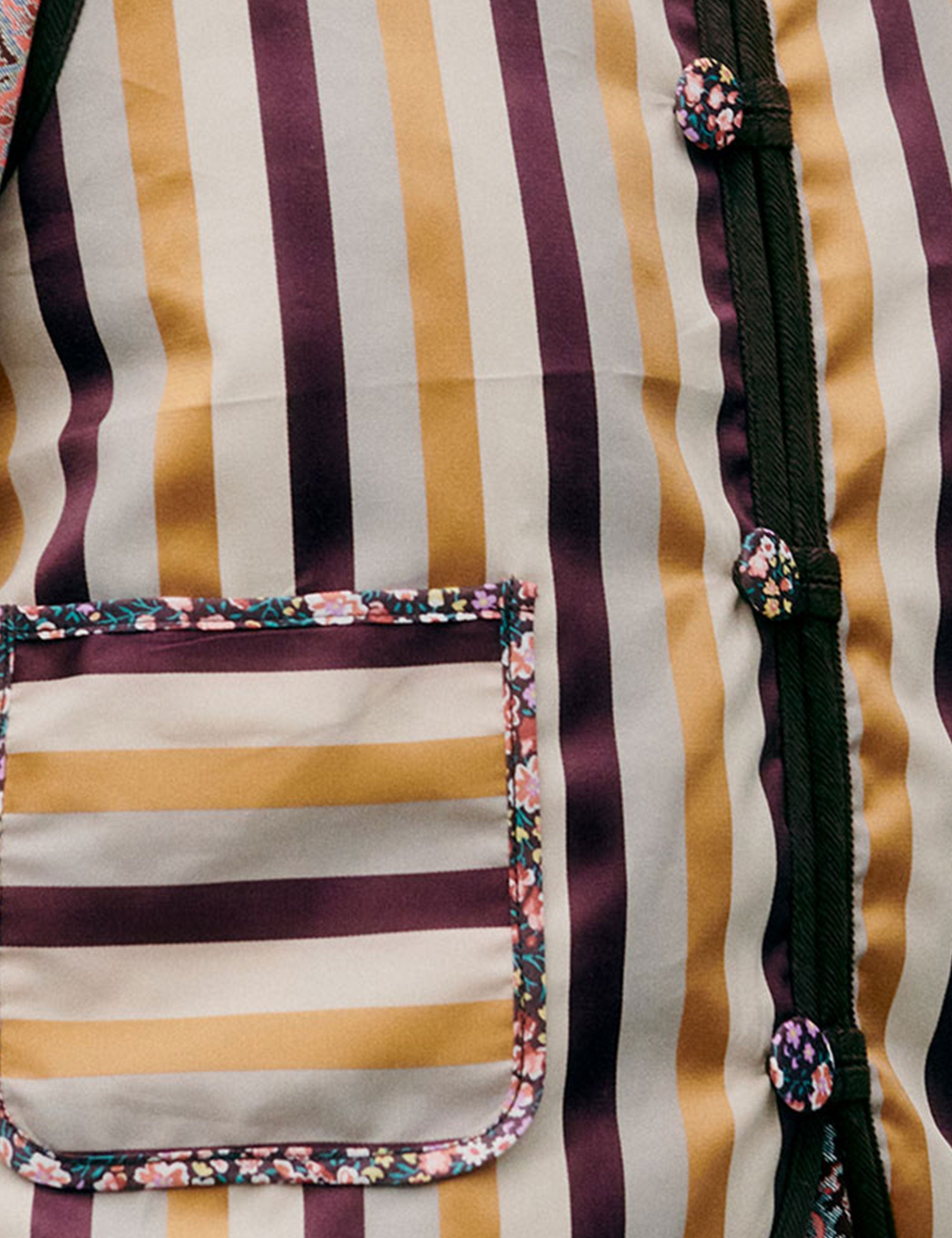 Striped fabric with floral trim and zipper detail