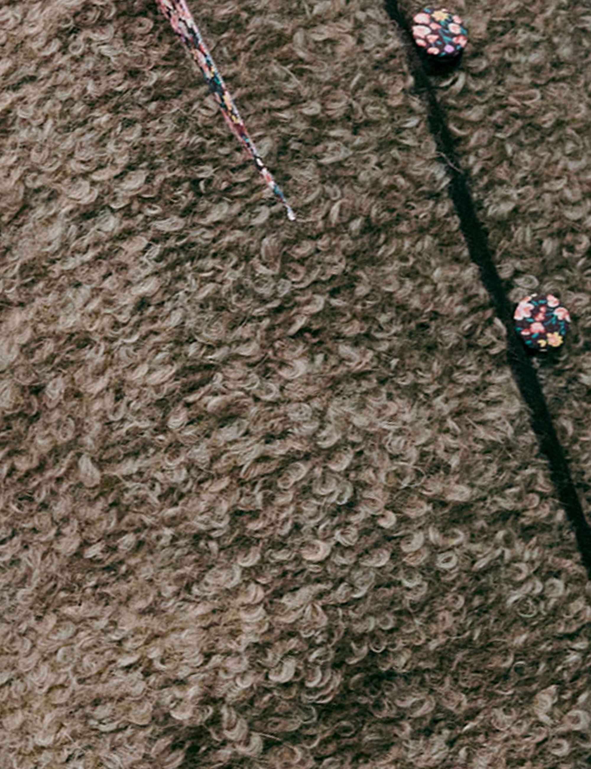 Close-up of a textured wool fabric surface with a seam.