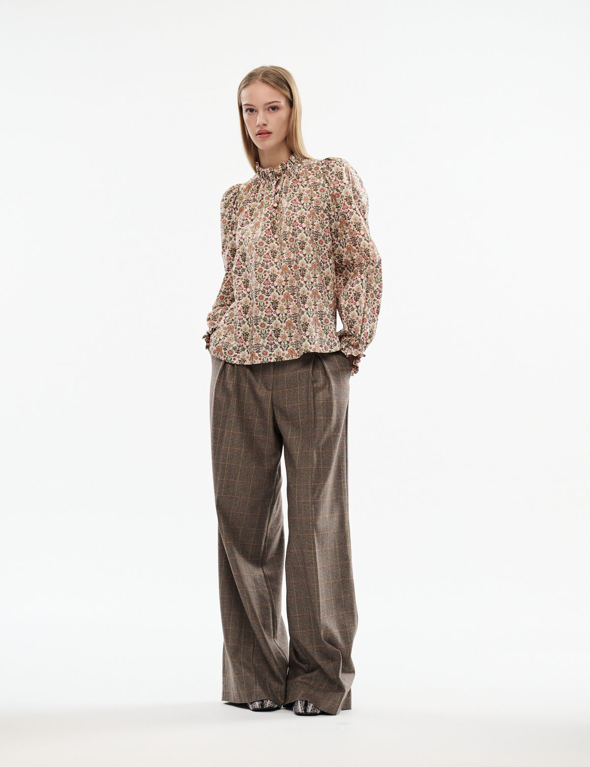 Brown plaid wide-leg trousers with loose drape and wide legs.