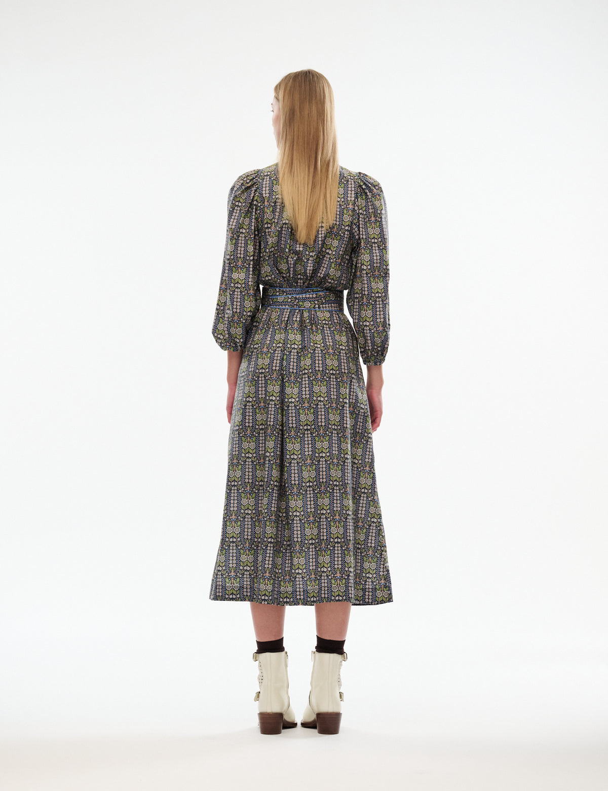 Maya midi dress back view with long sleeves, blue-green patterned fabric and waist belt