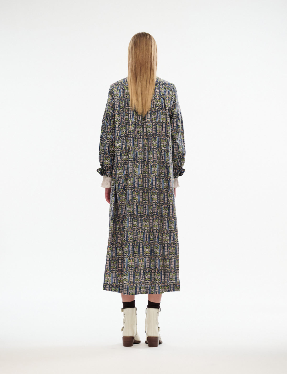 Mira dress back view with long sleeves, midi length, dark patterned fabric with floral motifs