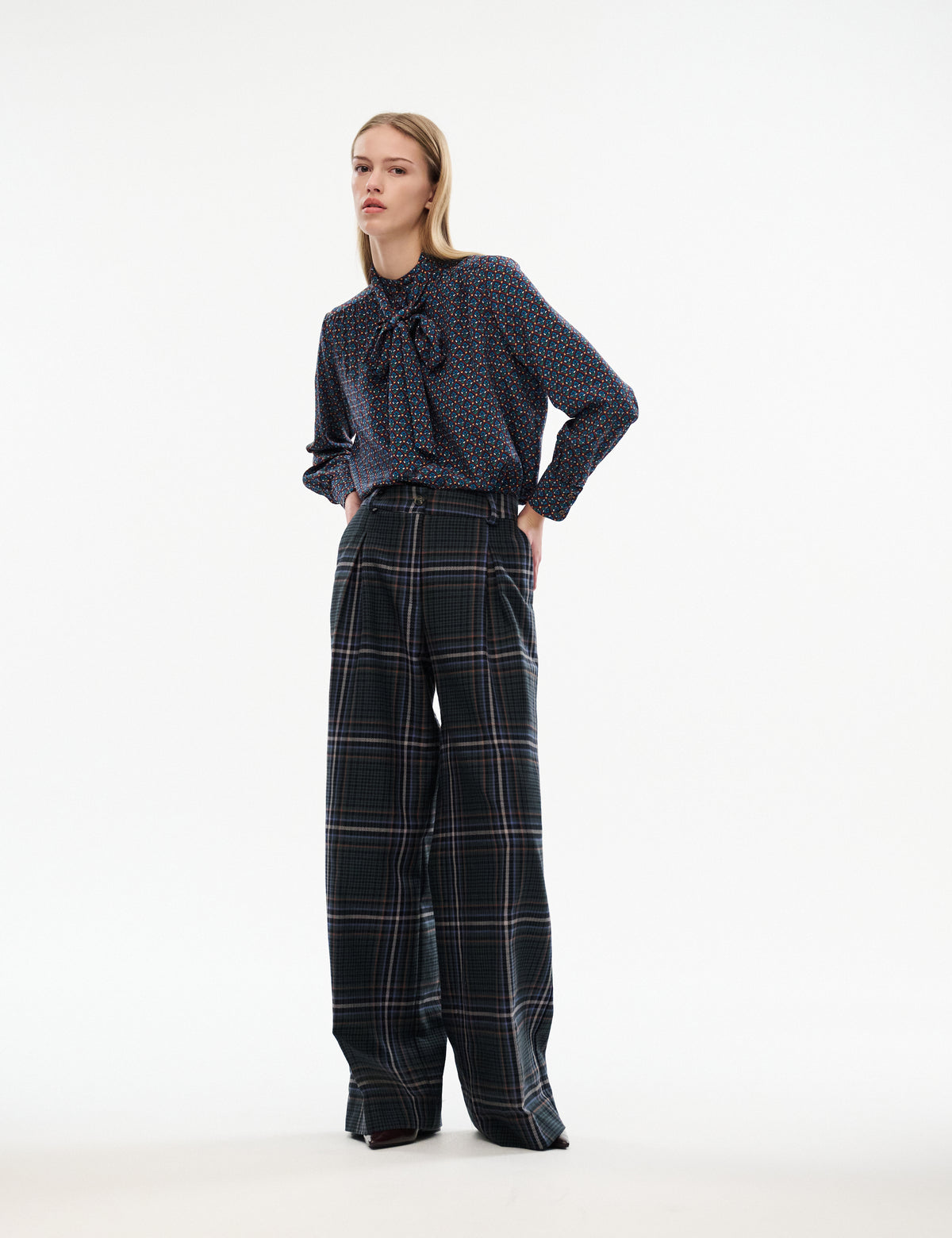 High-waisted wide-leg plaid trousers in dark navy/green with belt loops and button front.