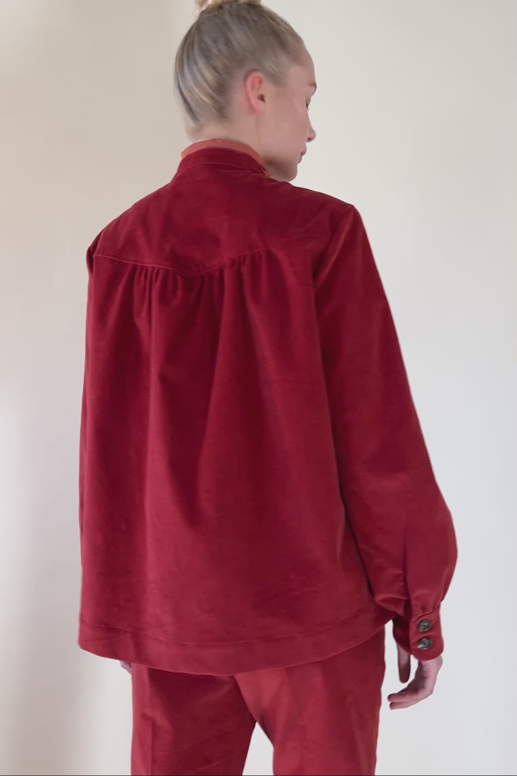 Woman in red babycord jacket and pants