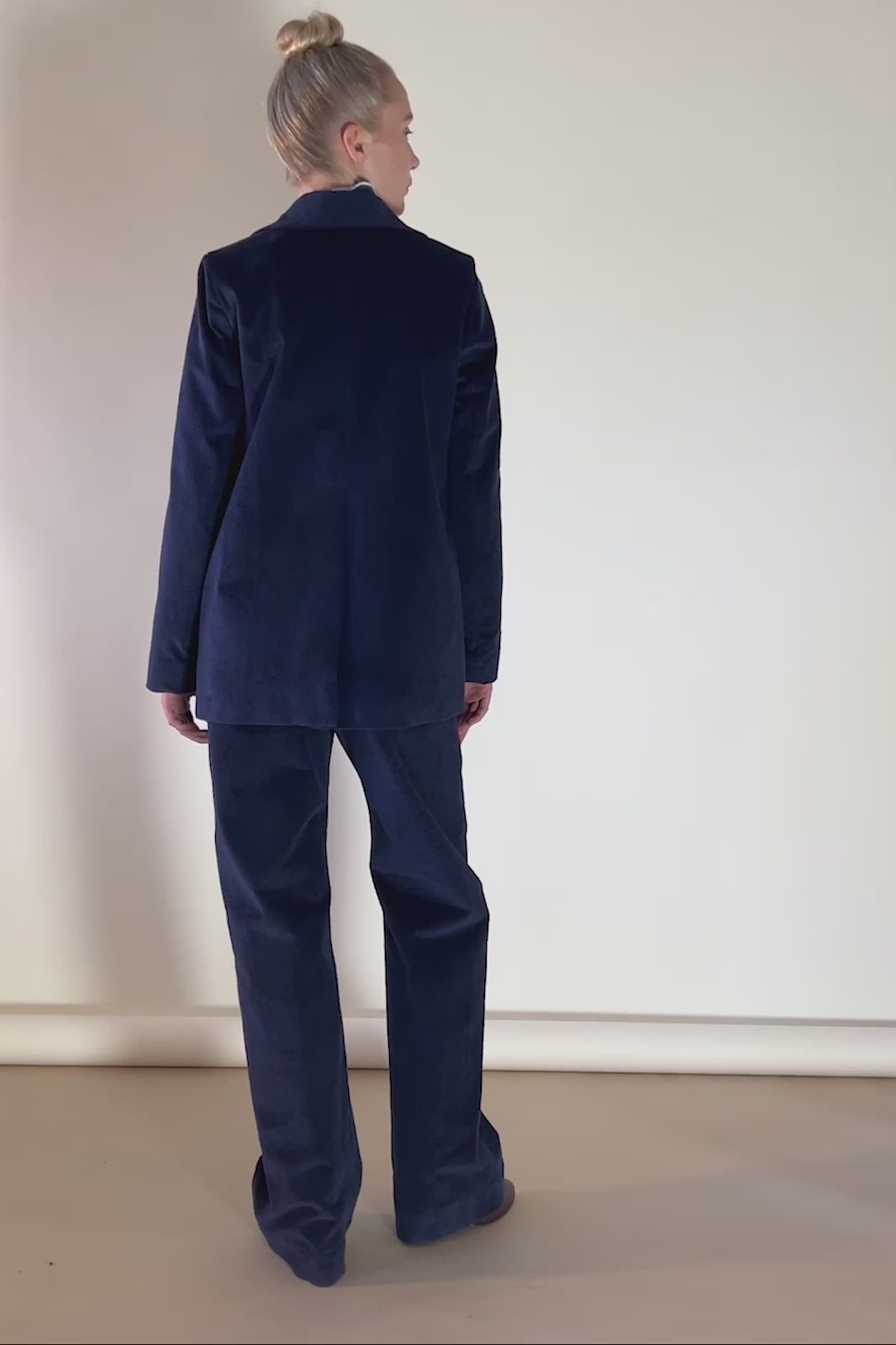 Woman in navy blue corduroy jacket and pants