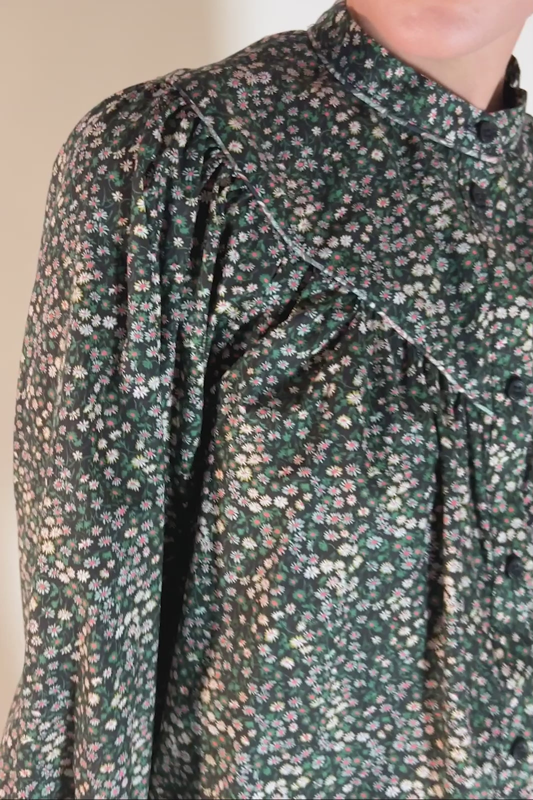 Woman in Liberty cotton shirt with Marguerite small floral print in black green and yellow and puff sleeves