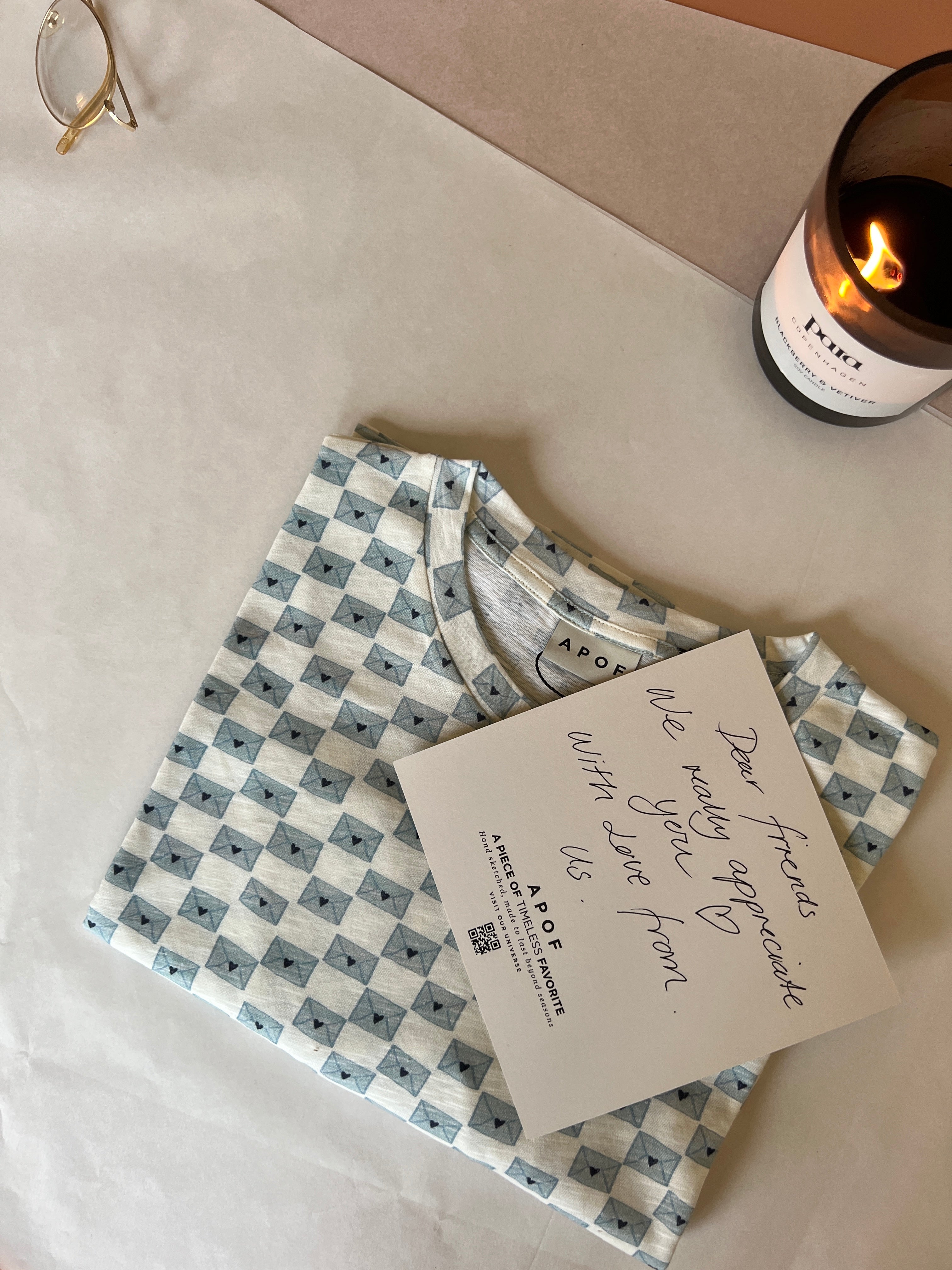 Folded women's t-shirt and note on table